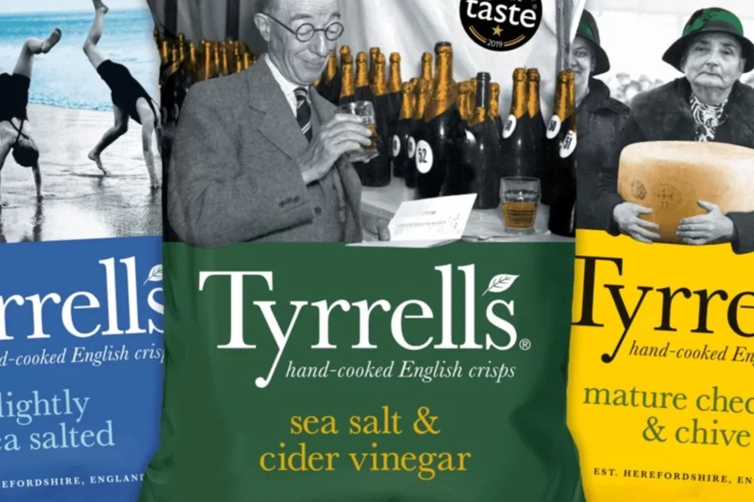 Colorful packaging of Tyrrell's English crisps with different flavors, including sea salt & cider vinegar, mature cheddar & chive, and lightly sea salted, with a black and white photo of elderly people holding beer and cheese at a tasting event, and 