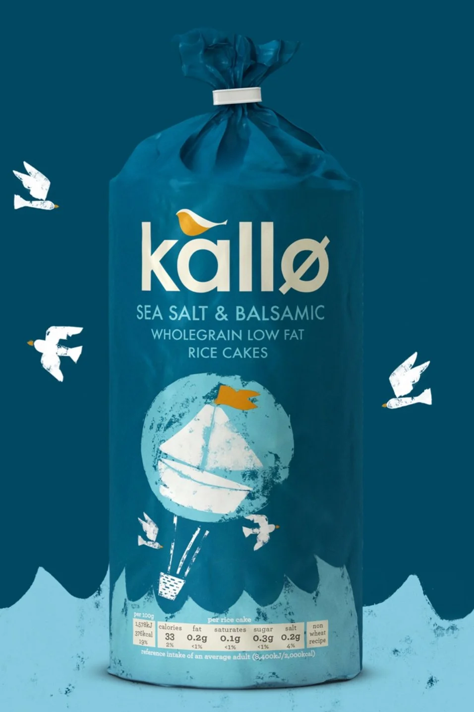 Blue package of Kallo sea salt and balsamic wholegrain low-fat rice cakes with illustrations of seagulls and a globe with a sailboat on it.