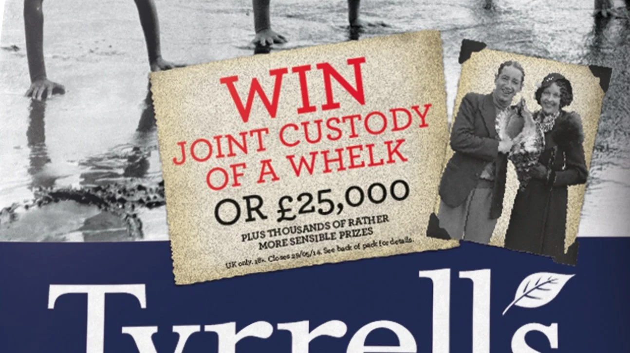 A promotional poster with a torn paper design. The main text reads "WIN JOINT CUSTODY OF A WHEEL OR £25,000" with smaller text about prizes and age restrictions. There is a black and white photograph of two women in vintage attire smiling and holding