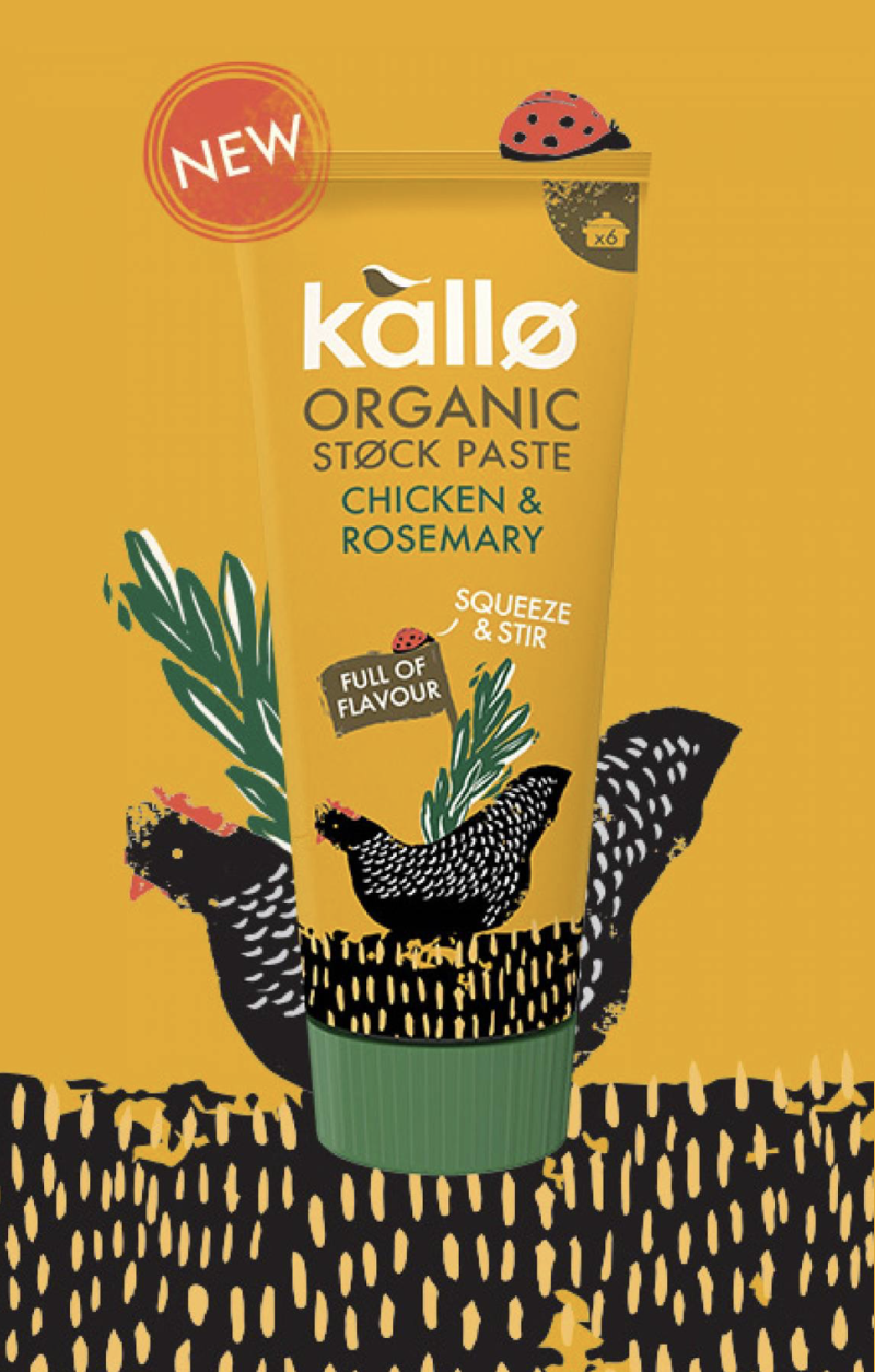 A bright yellow tube of Kallo organic stock paste with chicken and rosemary flavor, featuring a black hen illustration and a red ladybug on top, set against a decorative background with hen imagery.