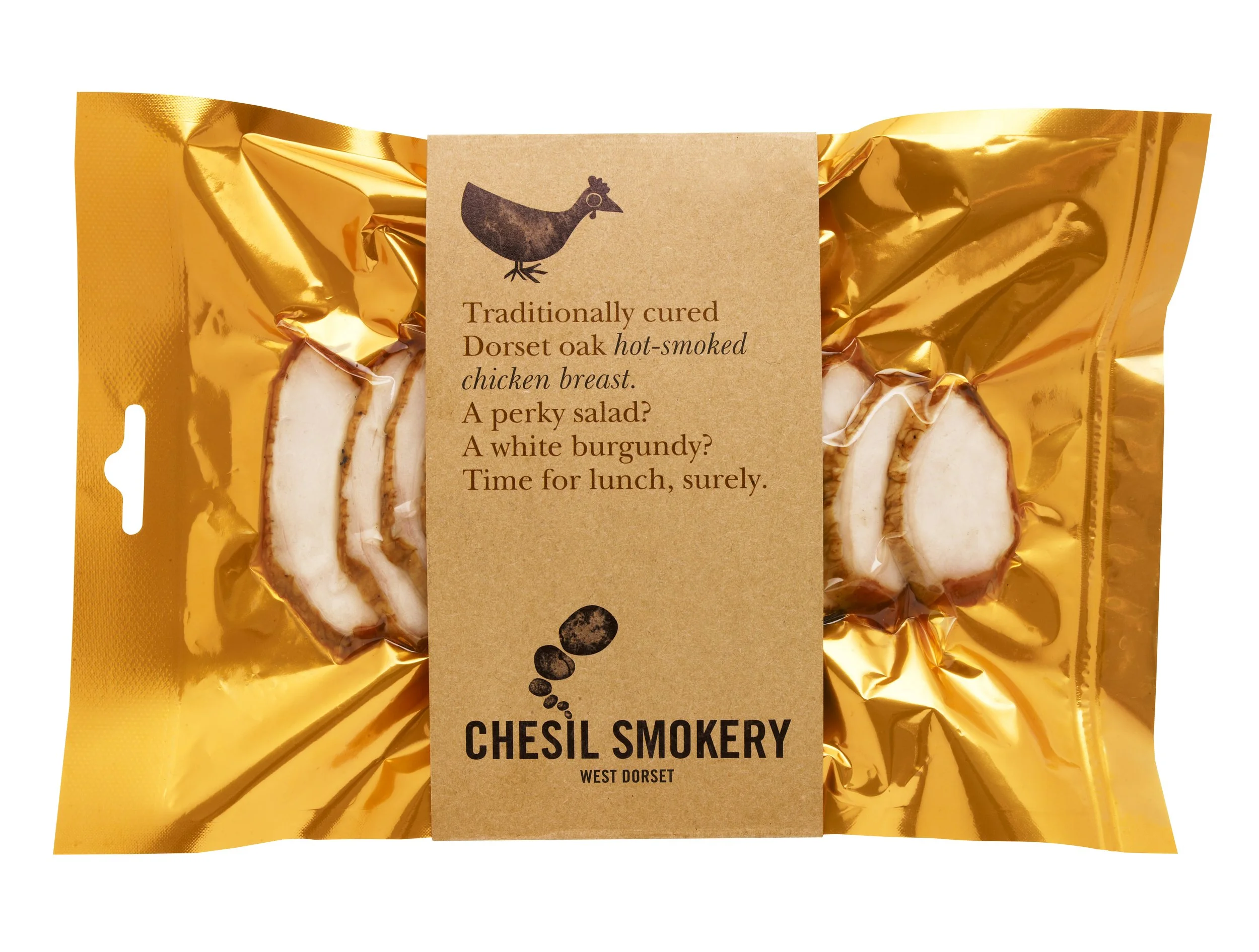 Vacuum-sealed packages of smoked chicken breast inside a shiny gold bag with a brown label, featuring black text and a chicken illustration.