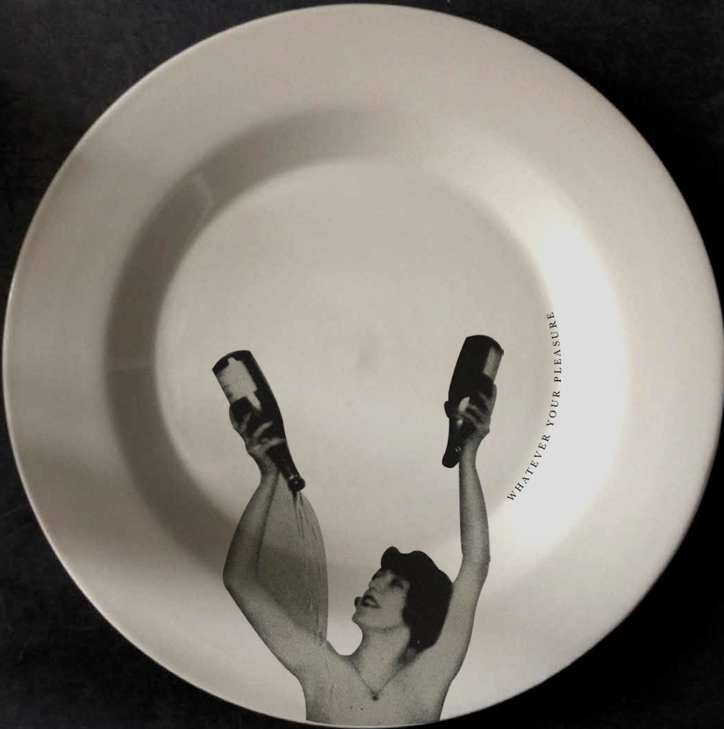 A white plate with black and white image of a woman holding two bottles, with the words "Whatever your pleasure" written on it.