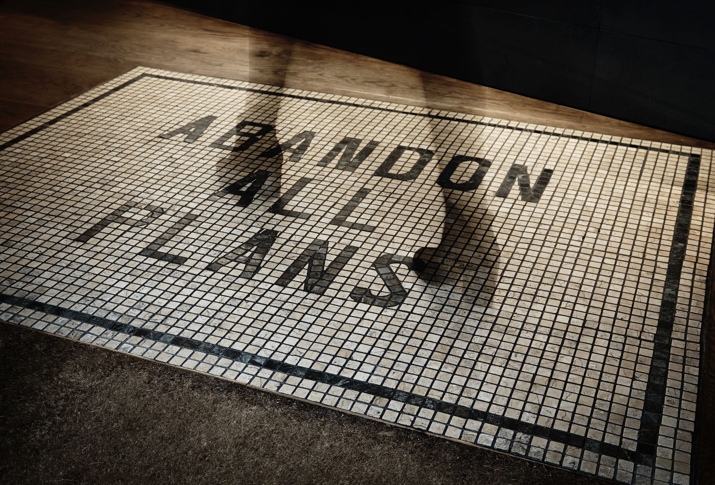 Welcome mat with black text that reads 'Welcome Aboard' on a tiled floor.
