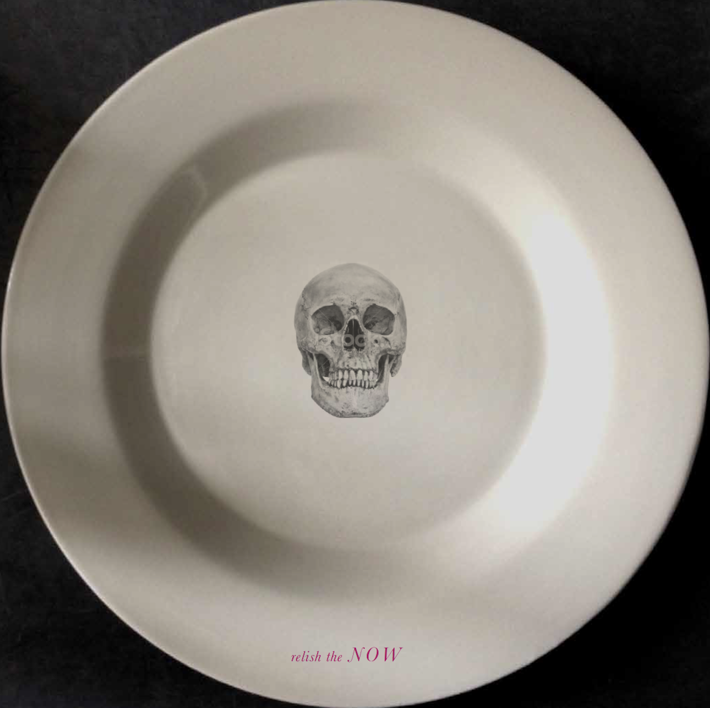 A white plate with a skull illustration in the center and the text 'relish the NOW' in pink at the bottom.