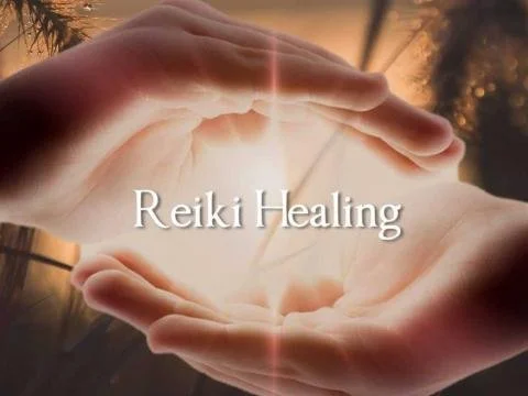 Two hands gently cupping light with the words 'Reiki Healing' in the center.