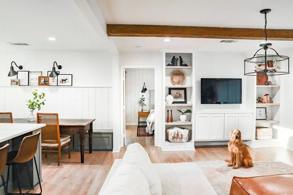 Bright living room with white built-in shelving and a comfortable gathering space