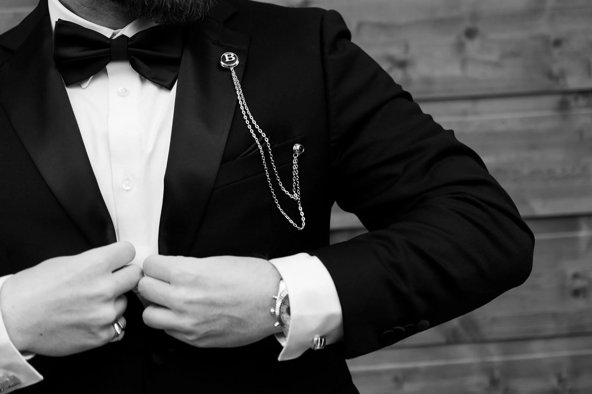 A groom putting on his tux.