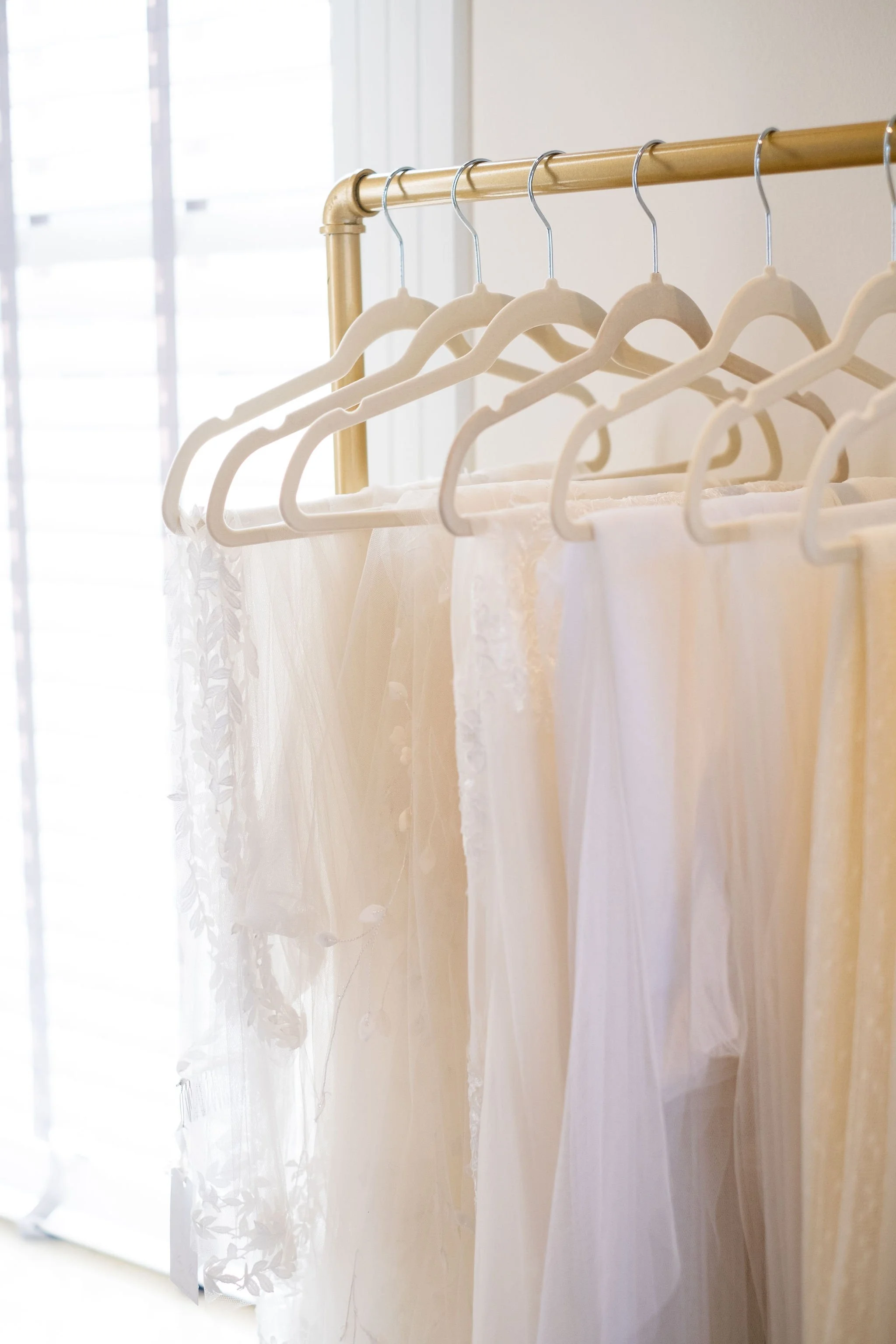 A rack full of wedding veils.
