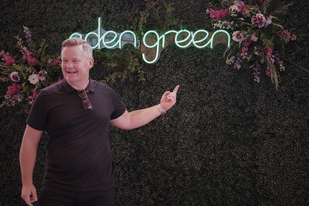 Man pointing to eden green neon sign1.jpg