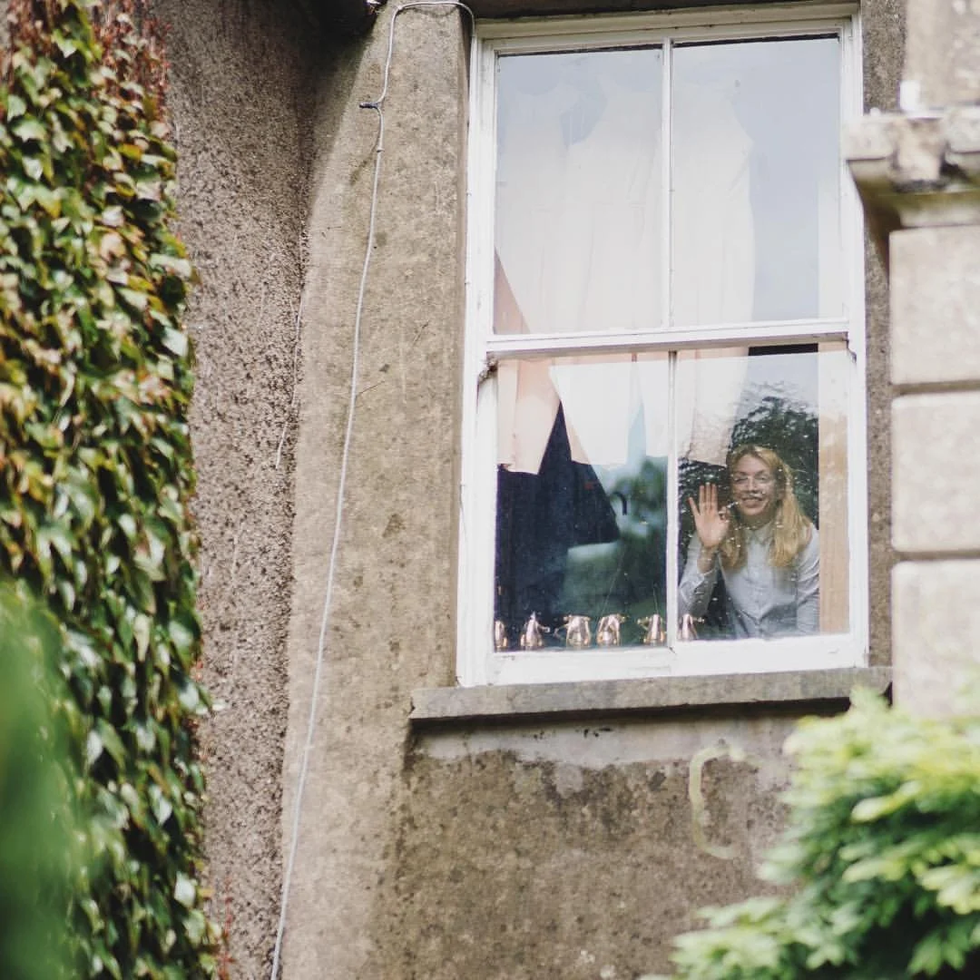 Louise Kiernan portrait - looking out window at wedding. Wedding films and invitations