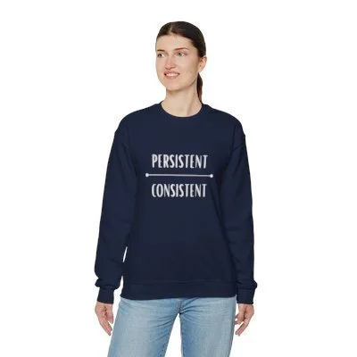A sweatshirt with the words "persistent" and "consistent" written on it, in white lettering. The text is stacked, with "persistent" on top and "consistent" below it. The sweatshirt appears to be worn and well-loved.