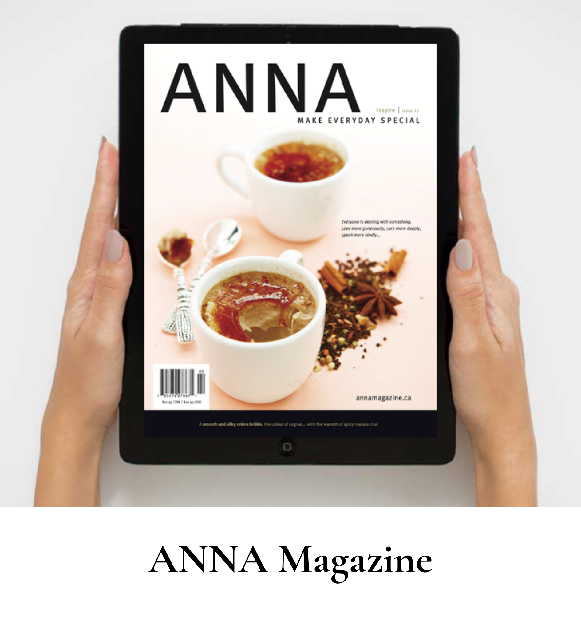 A person holding a tablet displaying the cover of ANNA Magazine, featuring two cups of chai with spices around them.