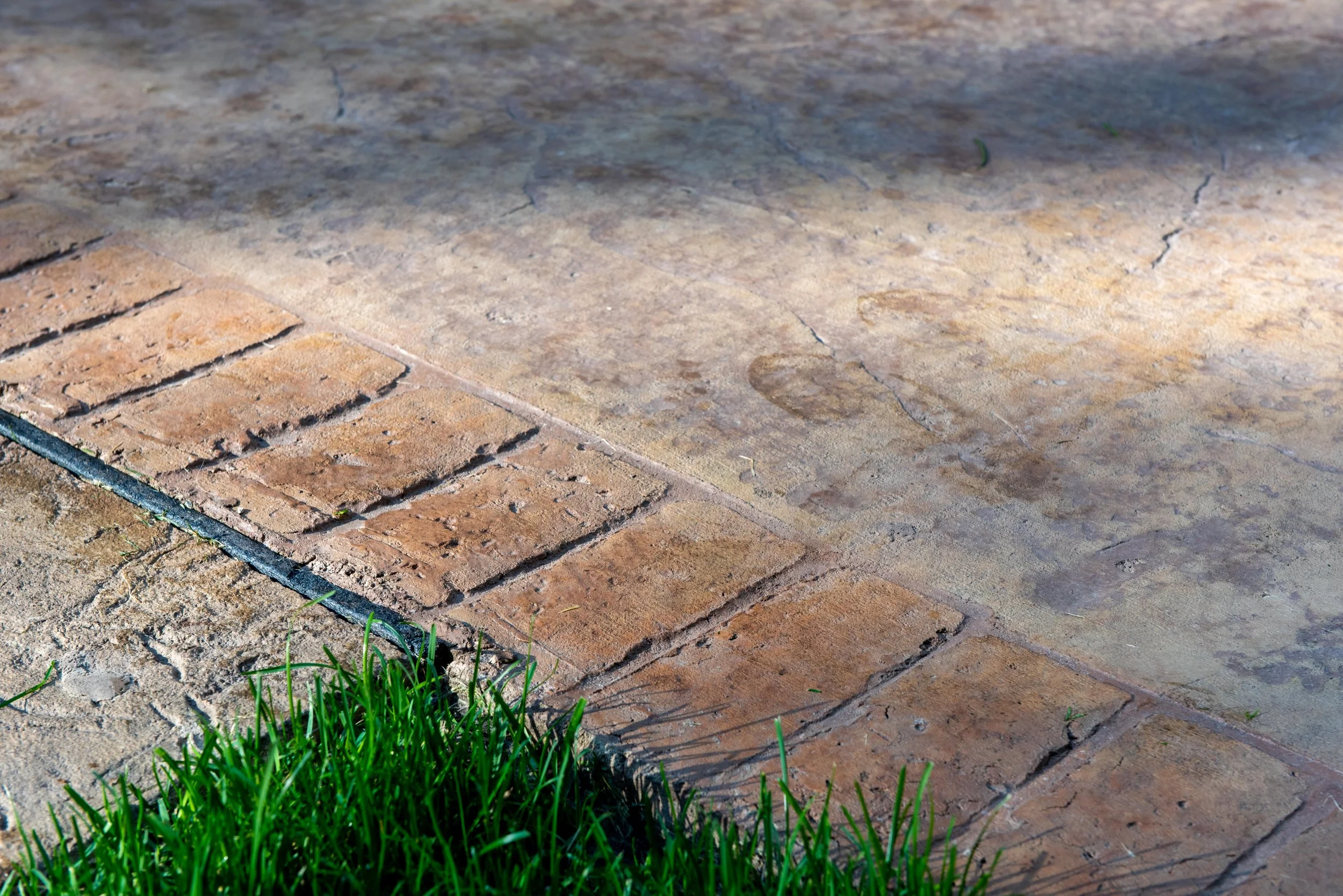 A close up of a brick and concrete sidewalk