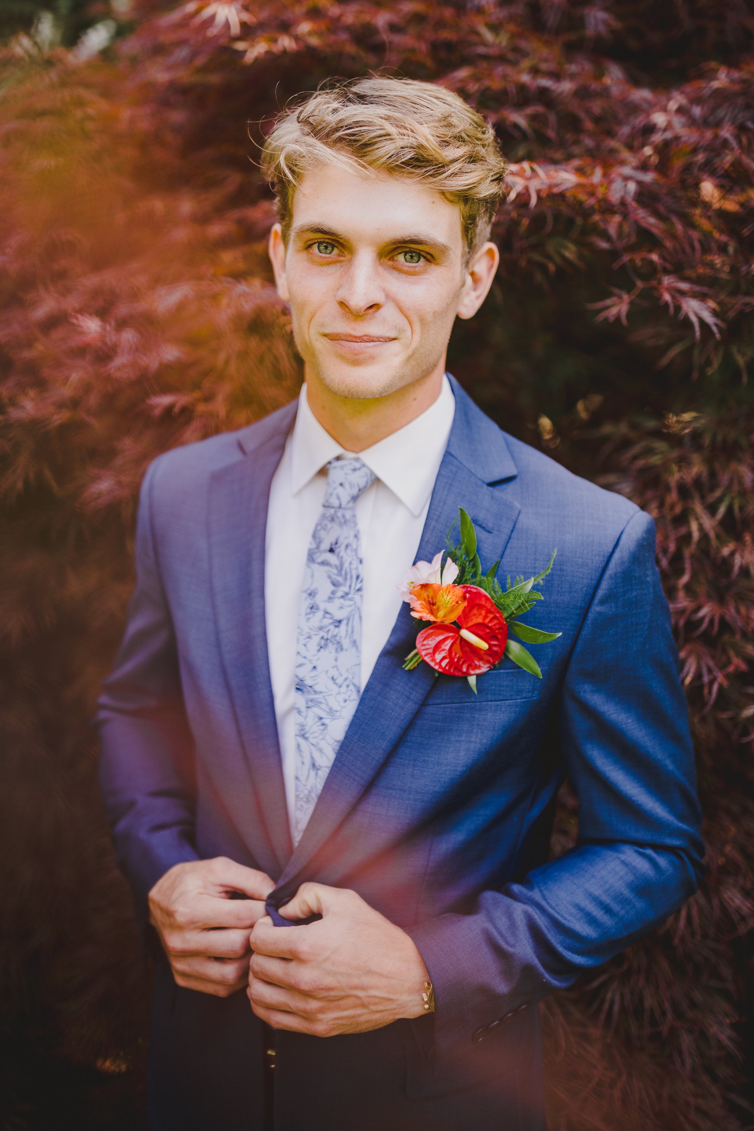 groom wearing tropical boutonniere