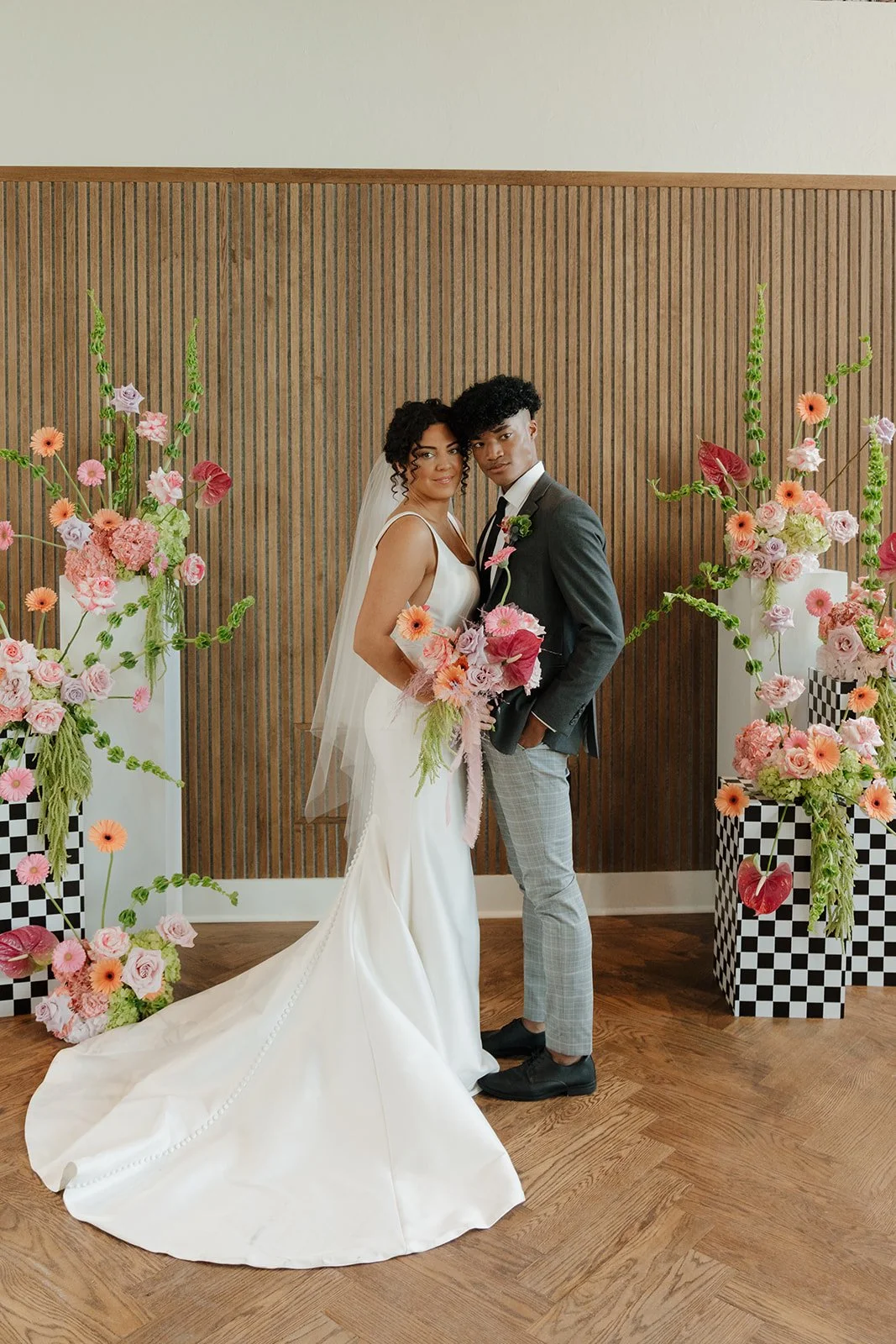 bride and groom with ceremony floral set up