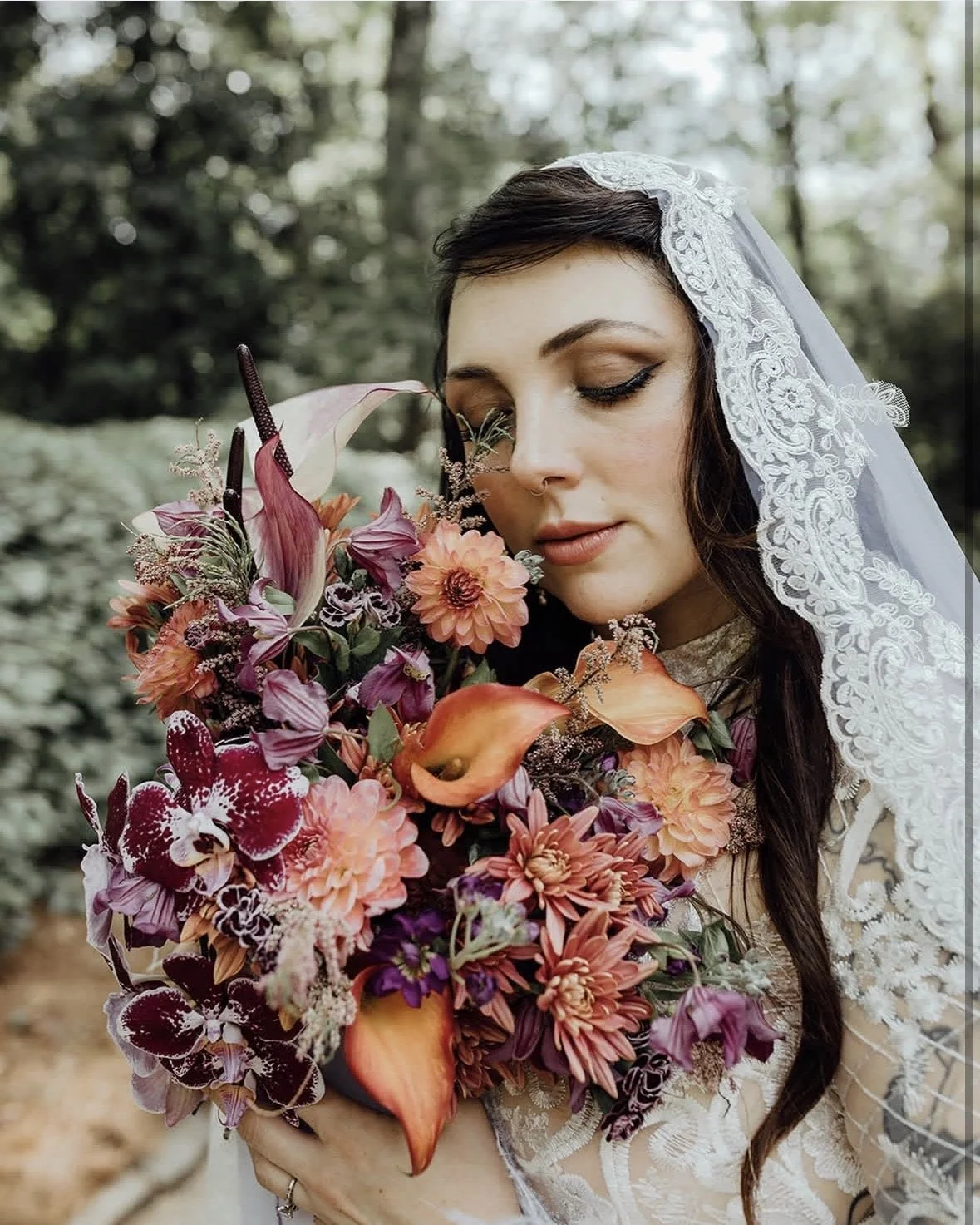 bride with lace veil and flower bouquet