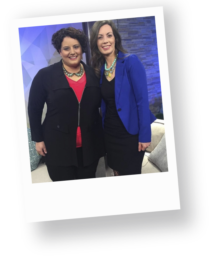 Sophia Apostol, a plus-size white woman and the founder of Fat Joy Creation Lab, stands in a red shirt and black jacket next to a white woman in a blue jacket, after being interviewed.