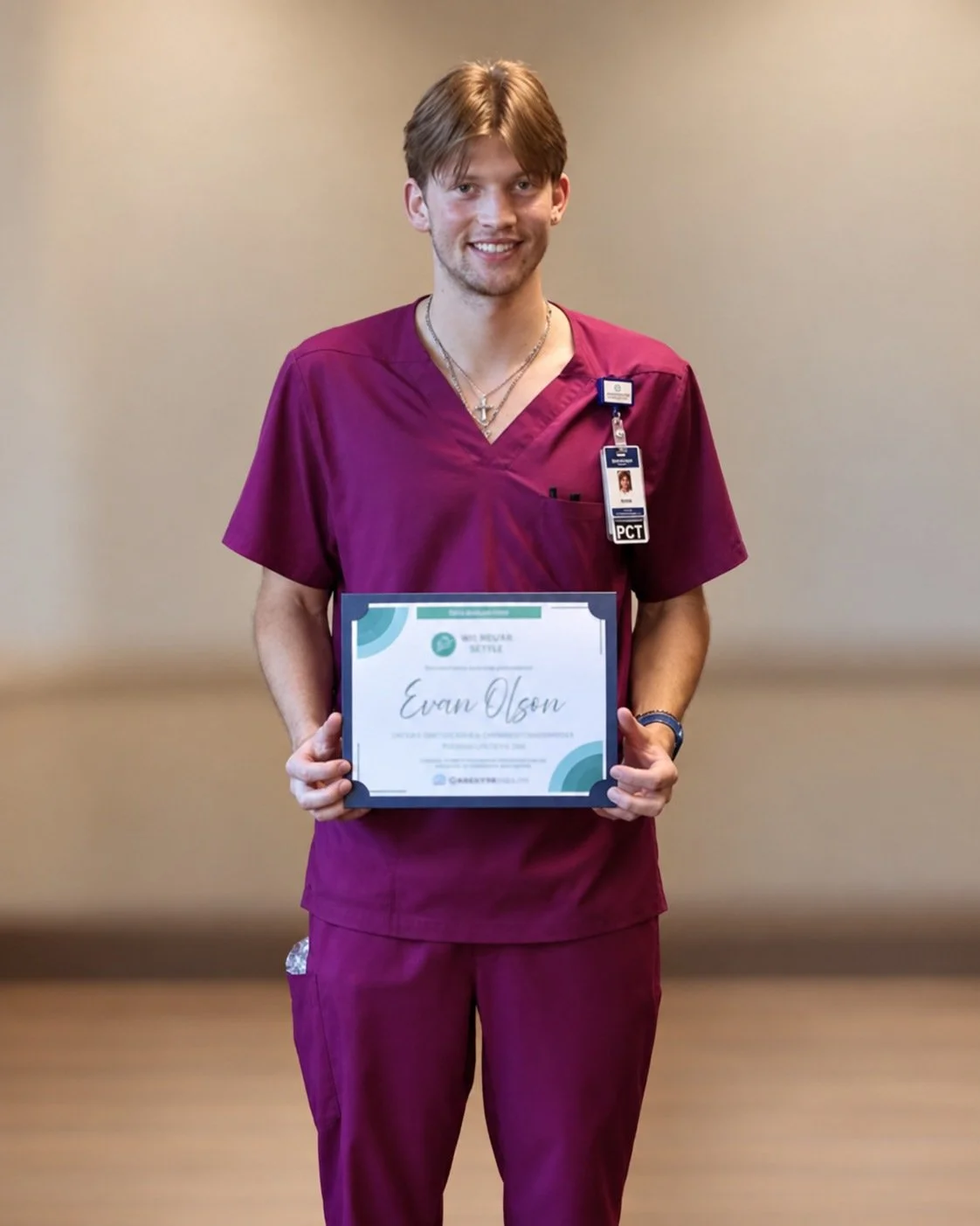 Evan Olson in marroon scrubs holding his Grandview Health Thankyou Thursday recognition certificate