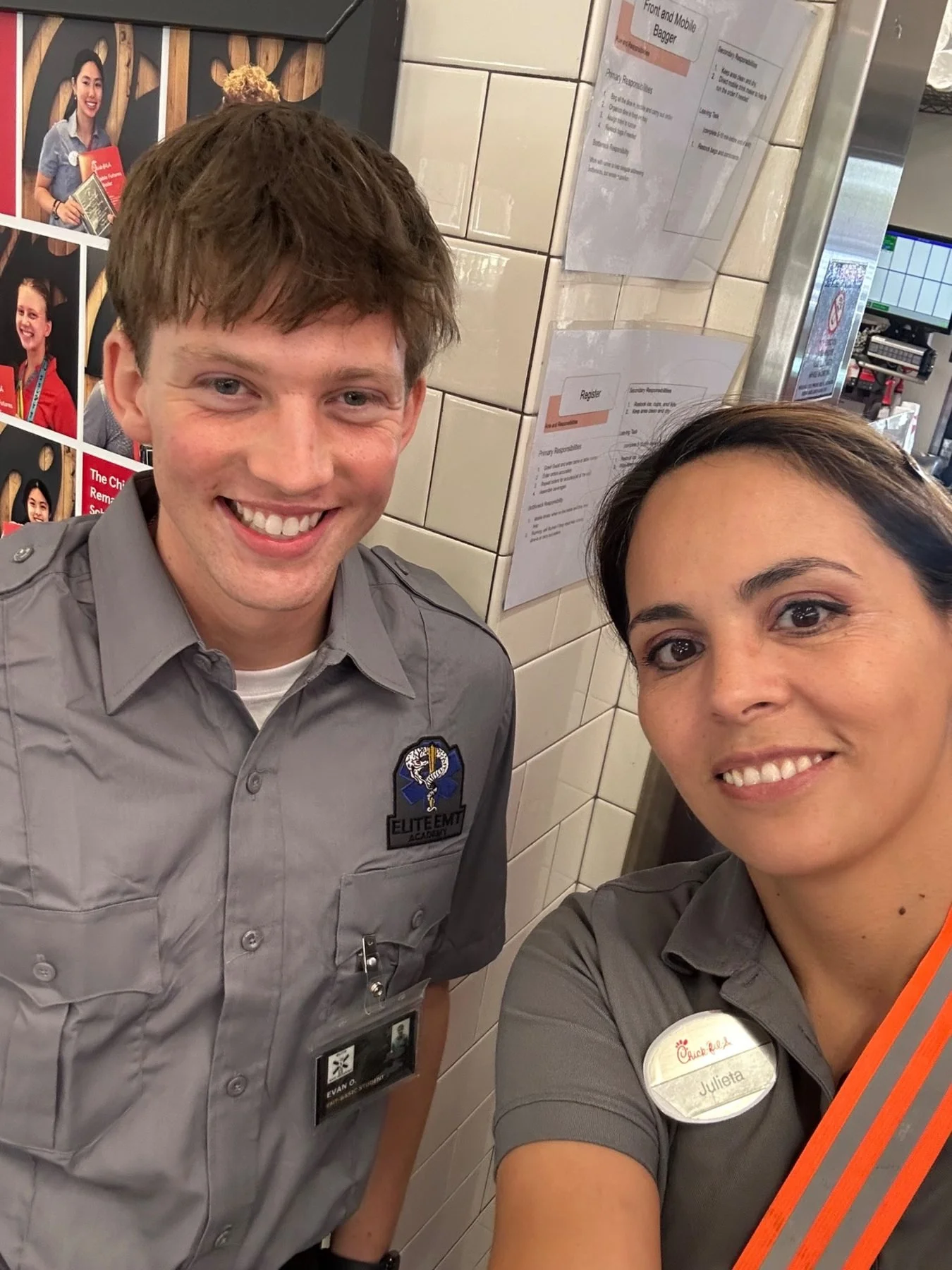 Evan Olson in a gray EMT Academy shirt beside Chick-fil-A Marketing director,Julieta.