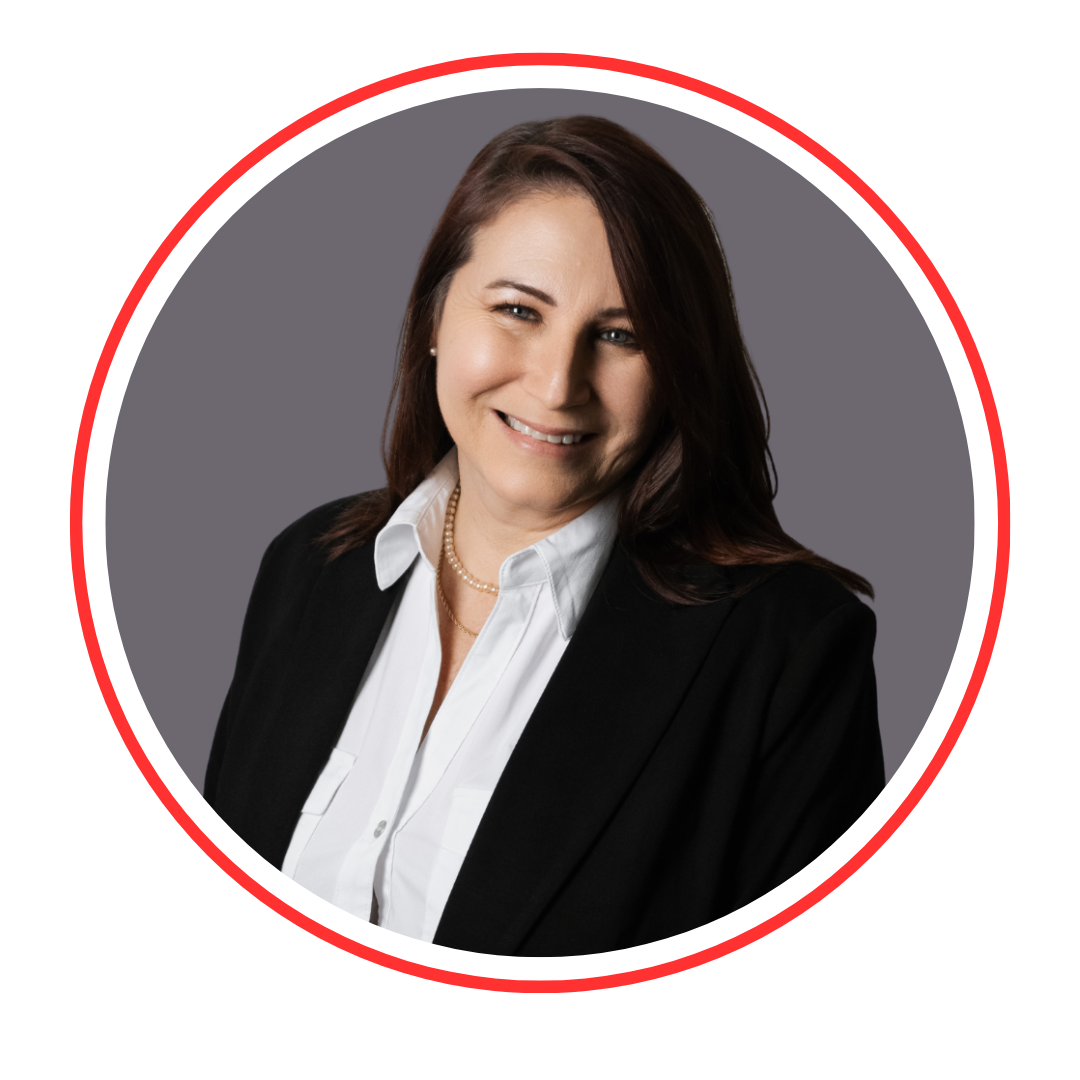 A professional woman with shoulder-length brown hair, wearing a black blazer and white shirt, smiling in front of a gray background
