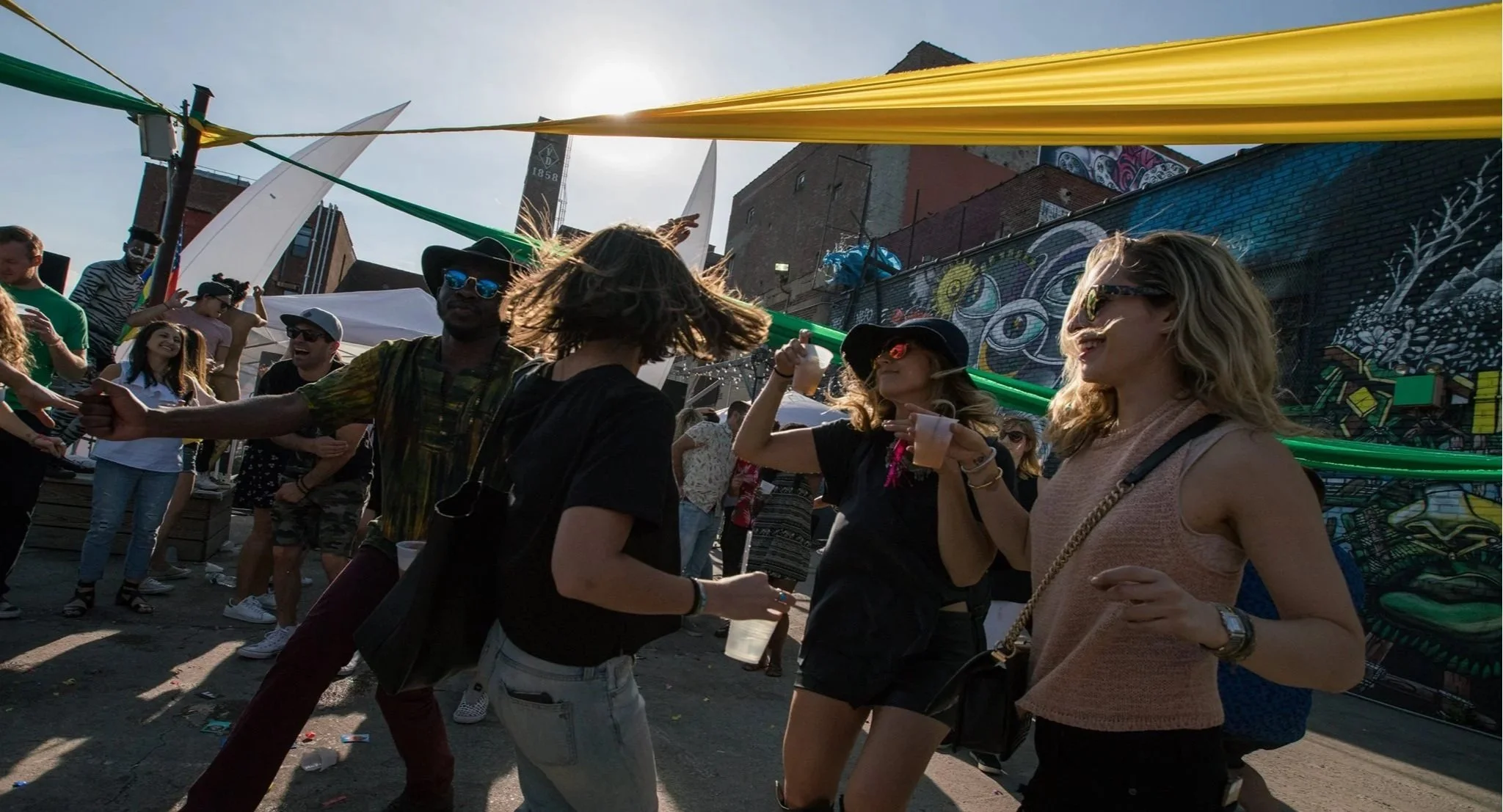 Guests dancing and celebrating at an outdoor event with Groove Approved DJ entertainment and immersive experiences.