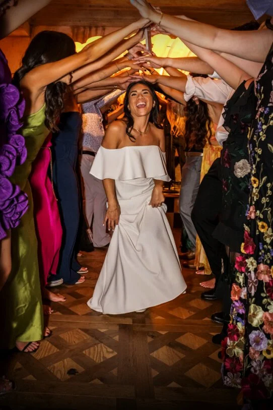 Bride dancing through a Soul Train line during a wedding reception at Lou Lou's Jungle Room in San Diego.