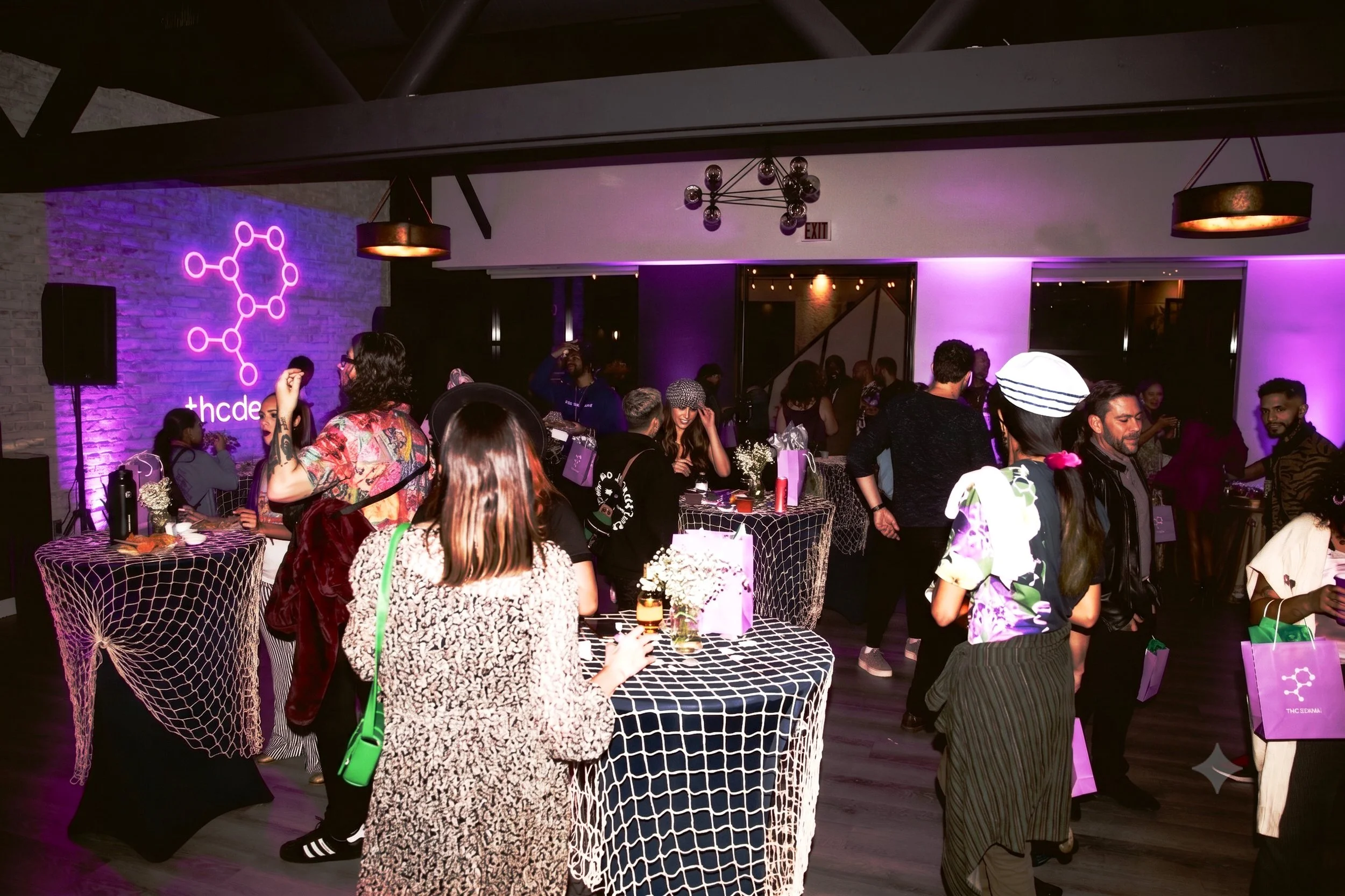 Guests celebrating at a THC Design holiday party with Groove Approved DJ, lighting, and event entertainment.