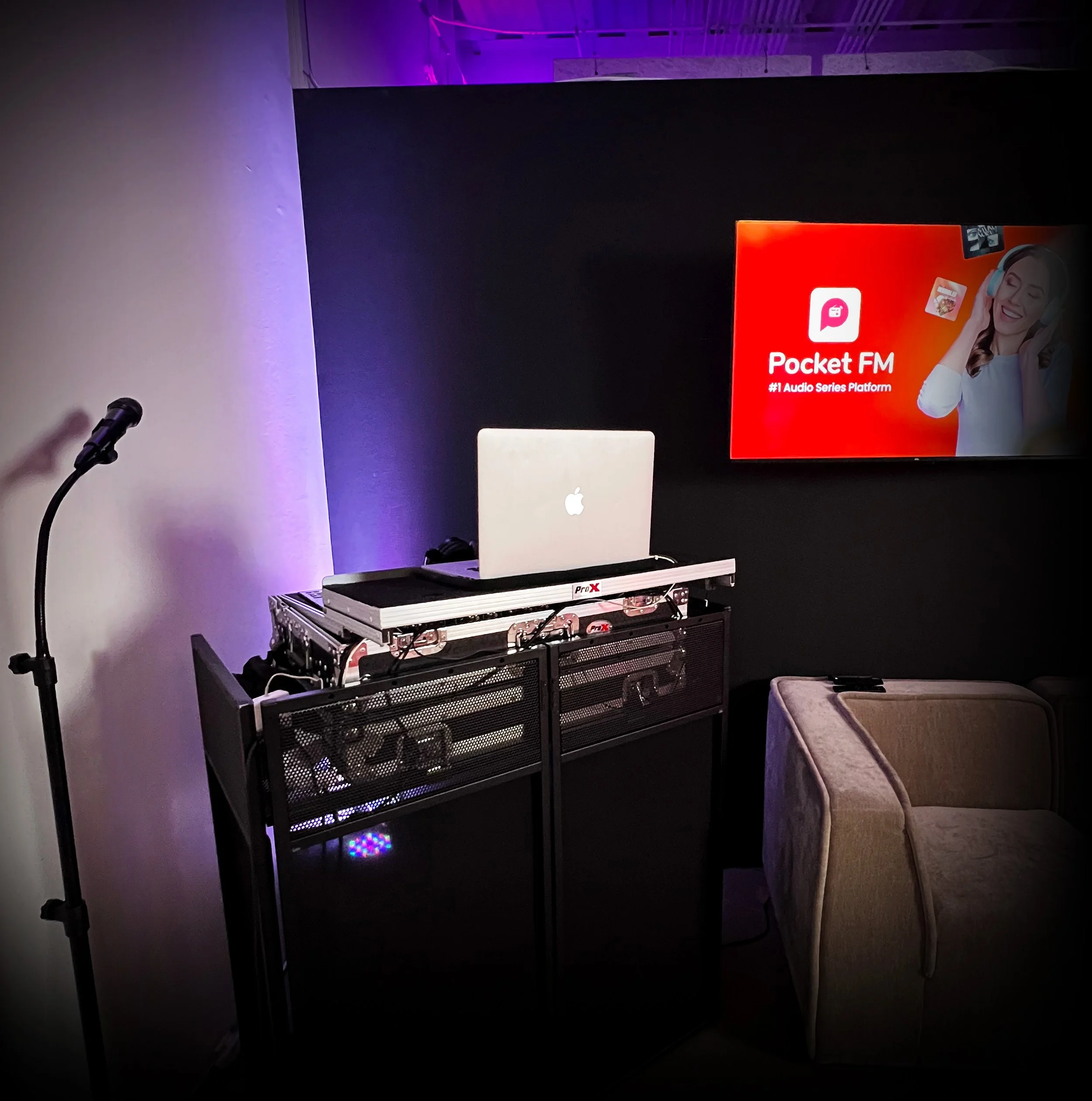 Professional Groove Approved DJ booth with Pioneer controller, laptop, and sound equipment for a corporate event.