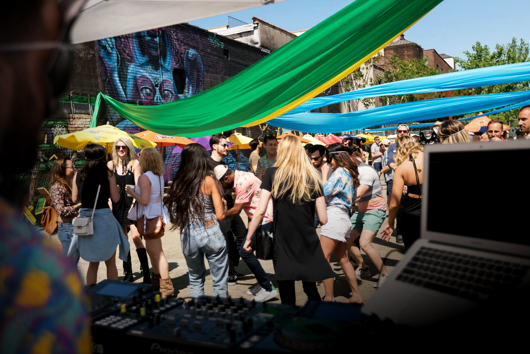 Outdoor event experience by Disco Tech Events featuring immersive fabric installations, curated entertainment, dynamic lighting, and an energized crowd.