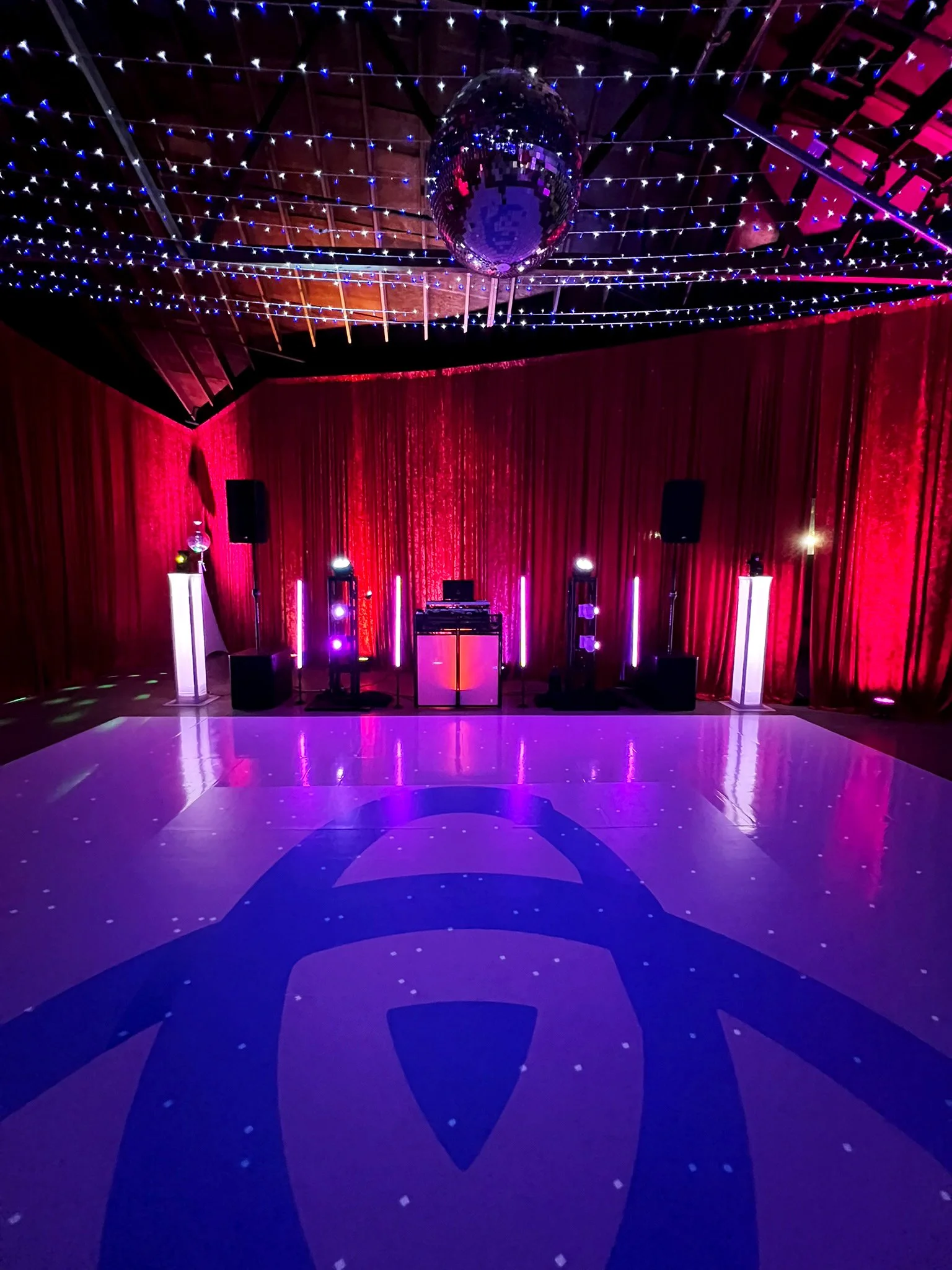 Dance floor lighting and professional DJ setup creating an unforgettable event atmosphere by Groove Approved.