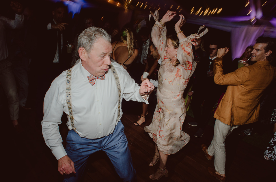 Father of the bride dancing with guests during high-energy wedding reception by Groove Approved DJ