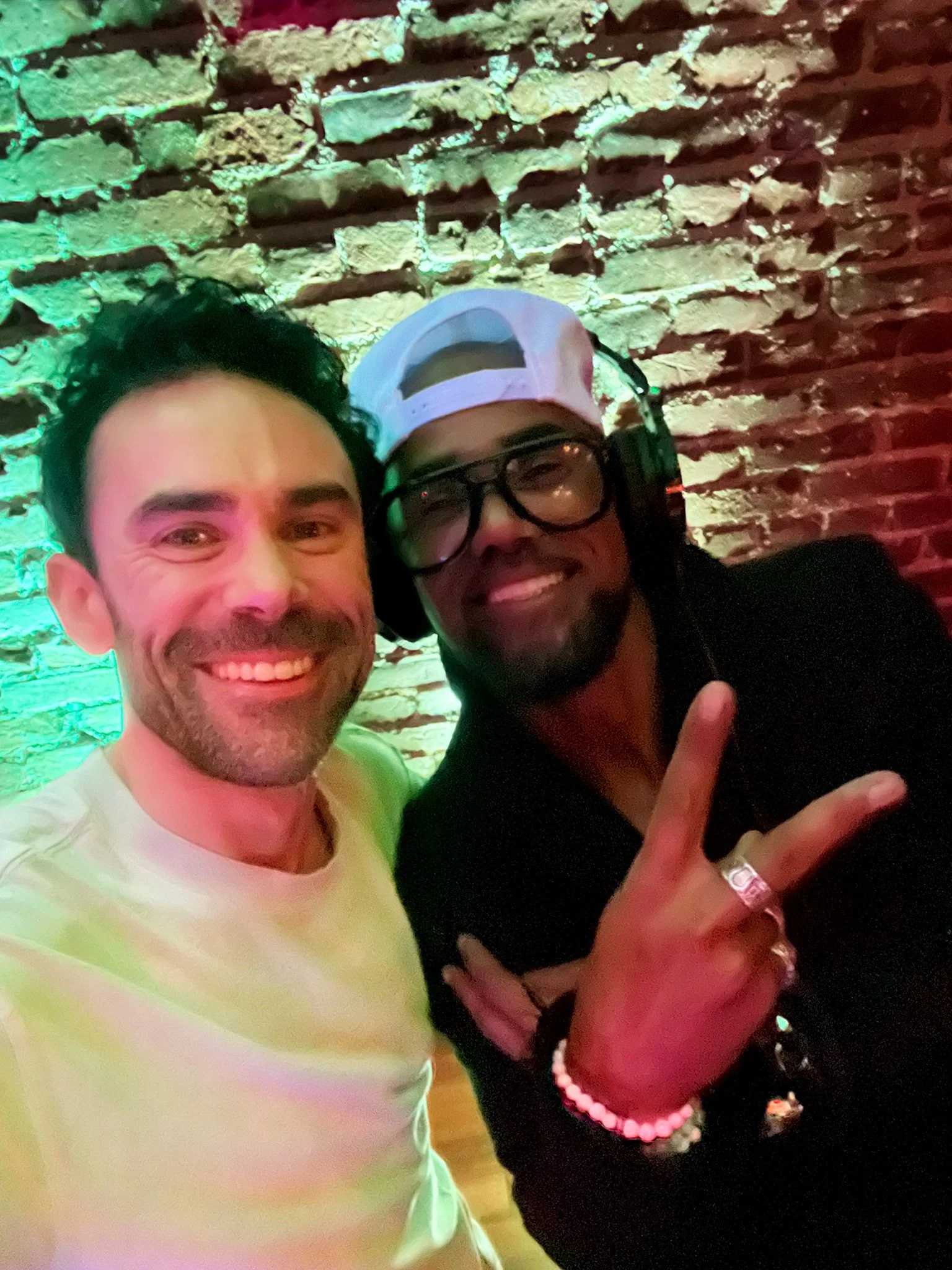 DJ Matty of Groove Approved taking a selfie with actor Shemar Moore at a corporate event in Los Angeles.