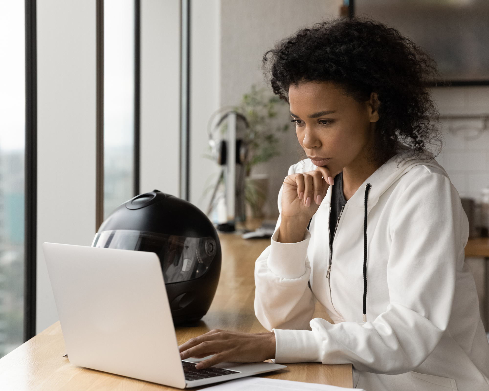 A light skinned biracial african american woman logs in for her virtual anxiety therapy session at Chicory Counseling