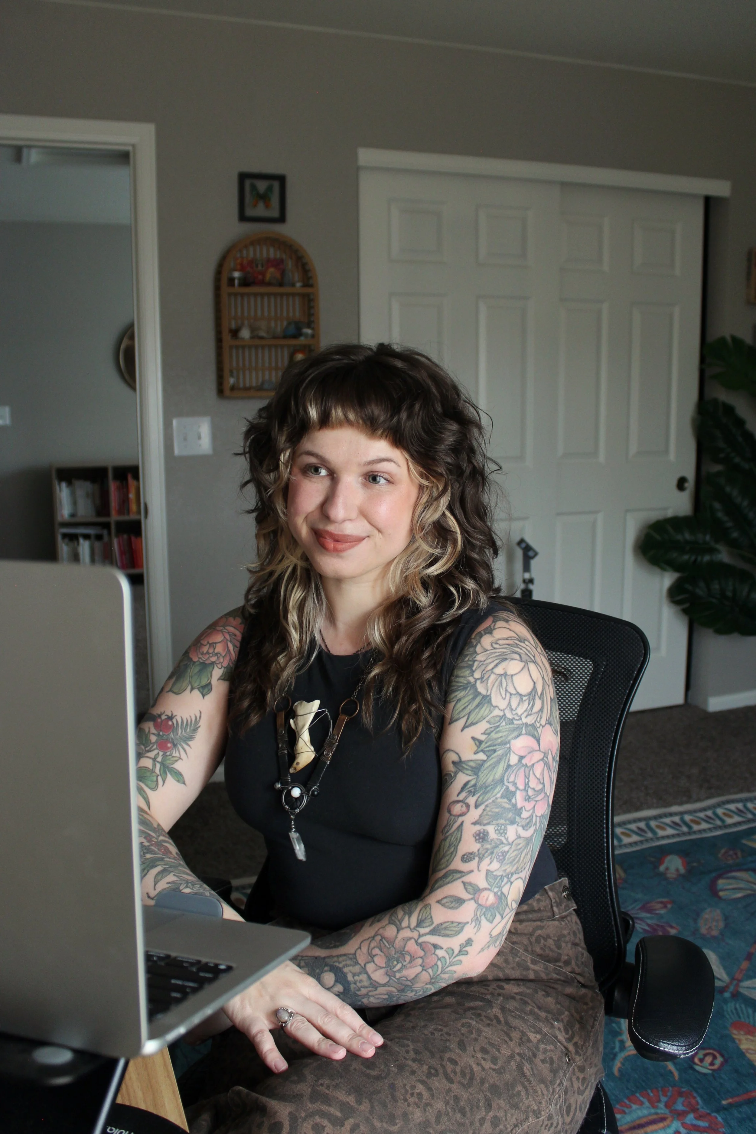 Image of Halle Thomas seated in front of a laptop