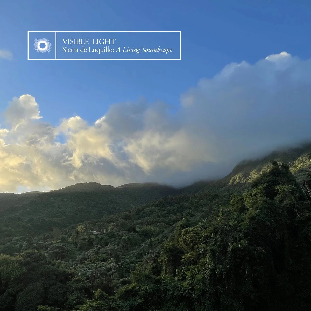 Photo of a lush green mountain landscape with clouds and blue sky, featuring the text overlay 'VISIBLE LIGHT Sierra de Luquillo: A Living Soundscape'.