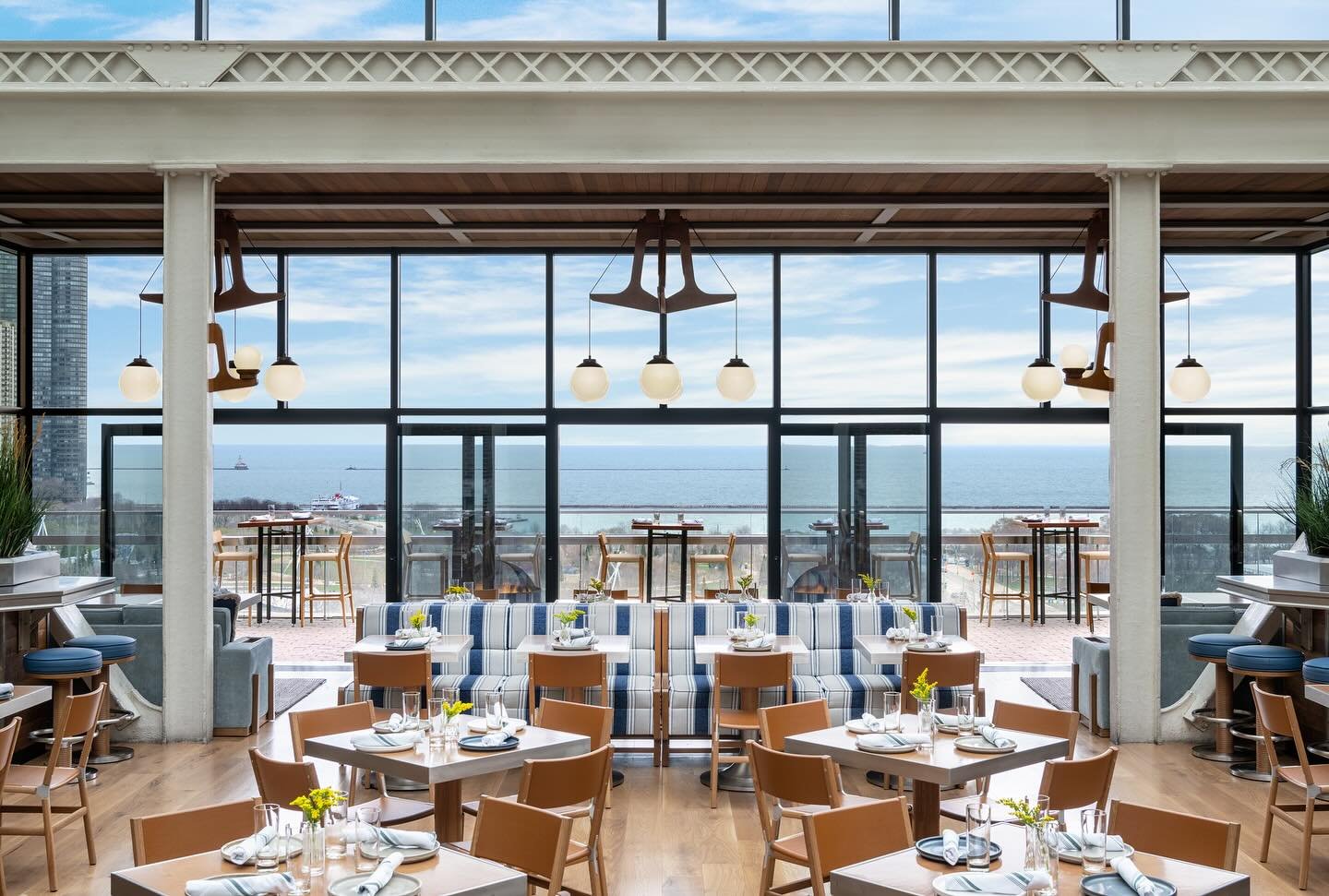 Within the existing steel atrium structure at Cindy&rsquo;s Rooftop, the refreshed look and feel was driven by its expansive views of Lake Michigan. Emphasizing the stunning architectural details already in place, we layered in lakehouse-inspired ele