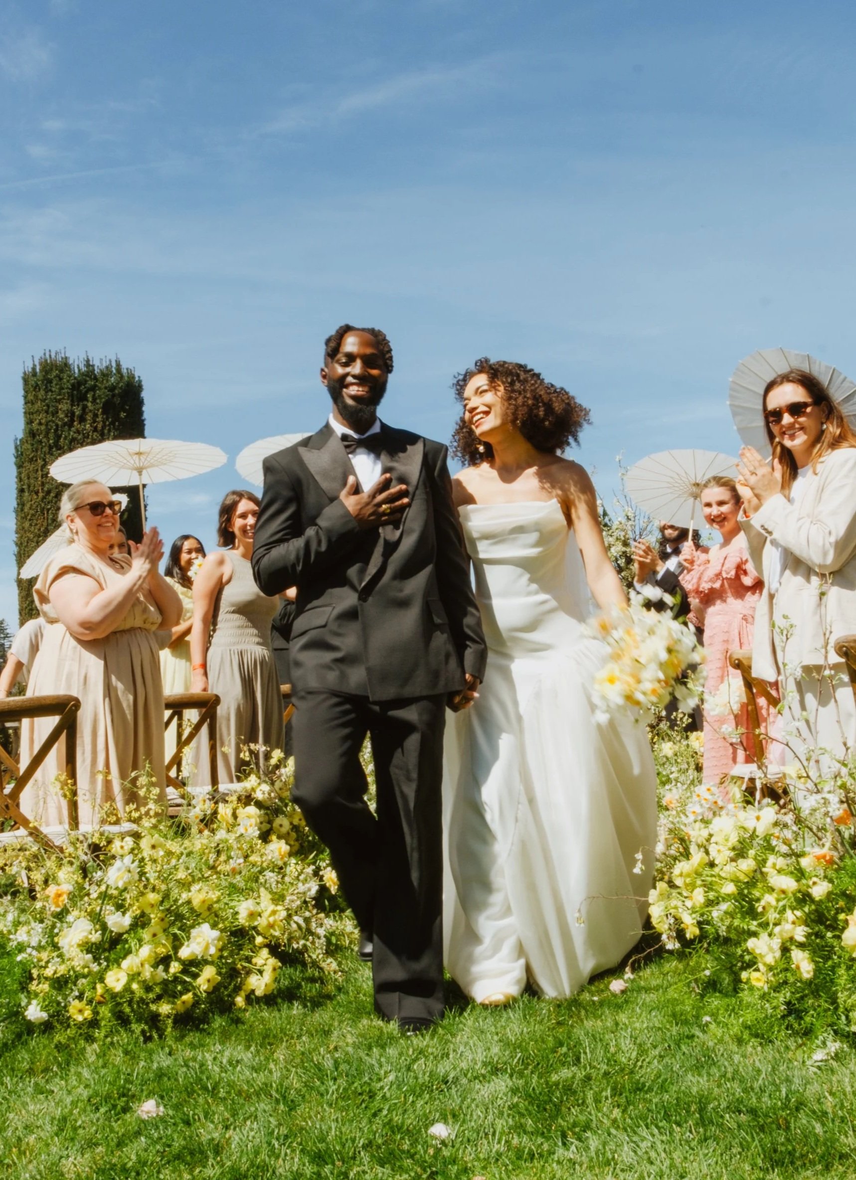 Bride & groom walking down the aisle while laughing and happy to be married