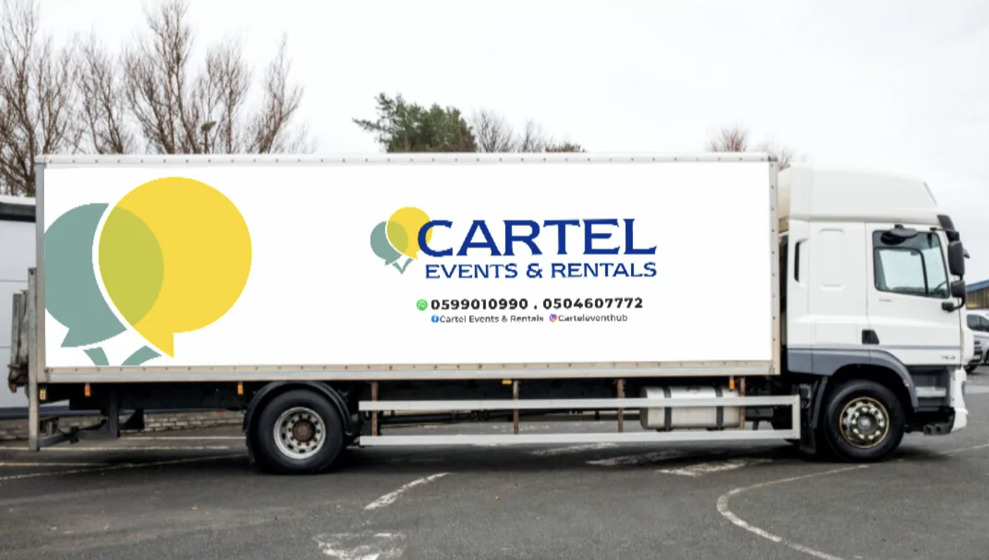 A white delivery truck with advertisements for Cartel Events & Rentals on the side, parked in a lot with other vehicles and leafless trees in the background.
