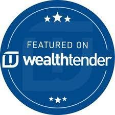  Blue circle with link with white logo saying “FEATURED ON” in smaller font and “wealthtender” in larger font below it. The WealthTender Logo is to the left of the words “wealthtender.” Three stars on both the top and bottom of logo. 