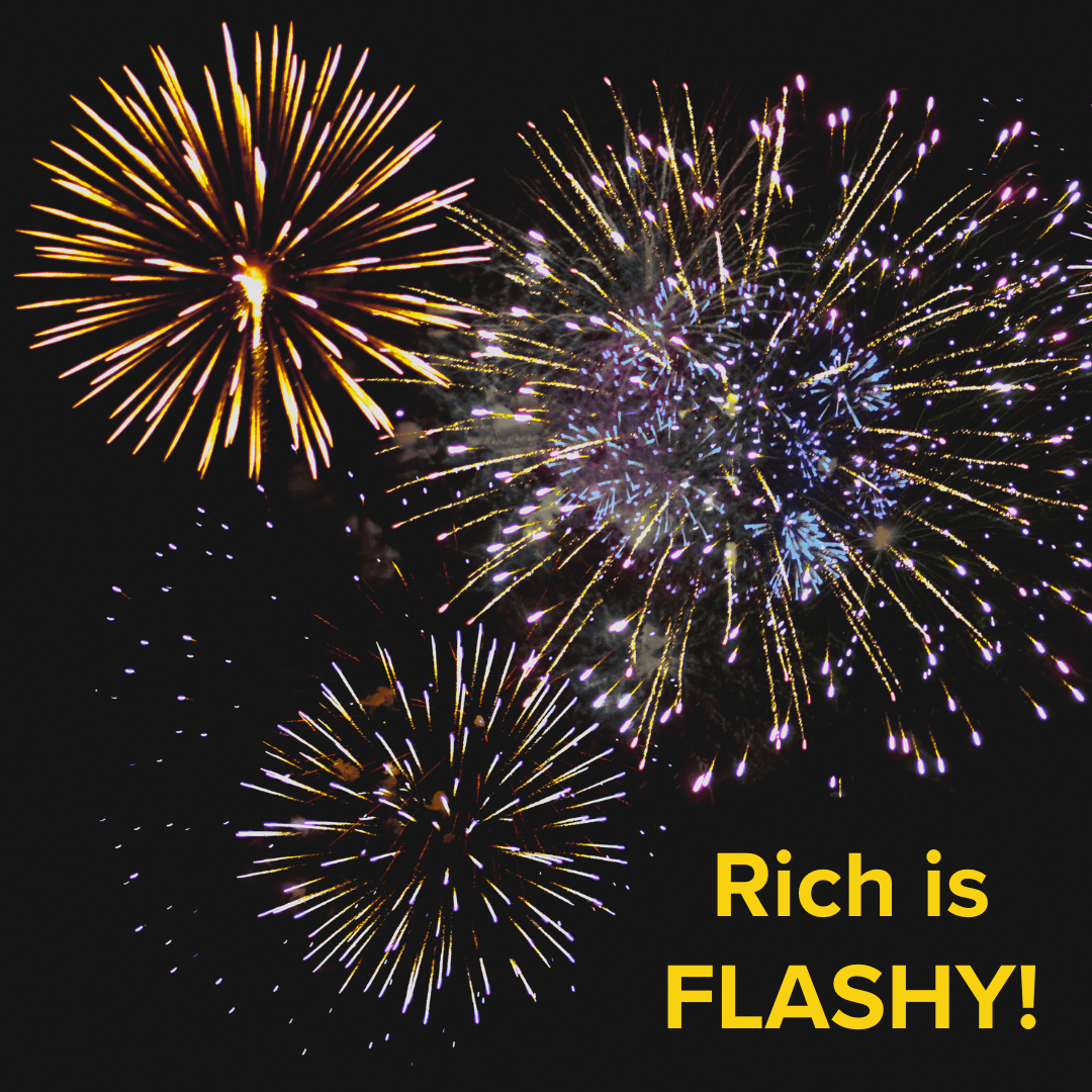 Title: "Rich is FLASHY!" in yellow in the bottom-right. The image is of many fireworks going off at once in a dark night sky.