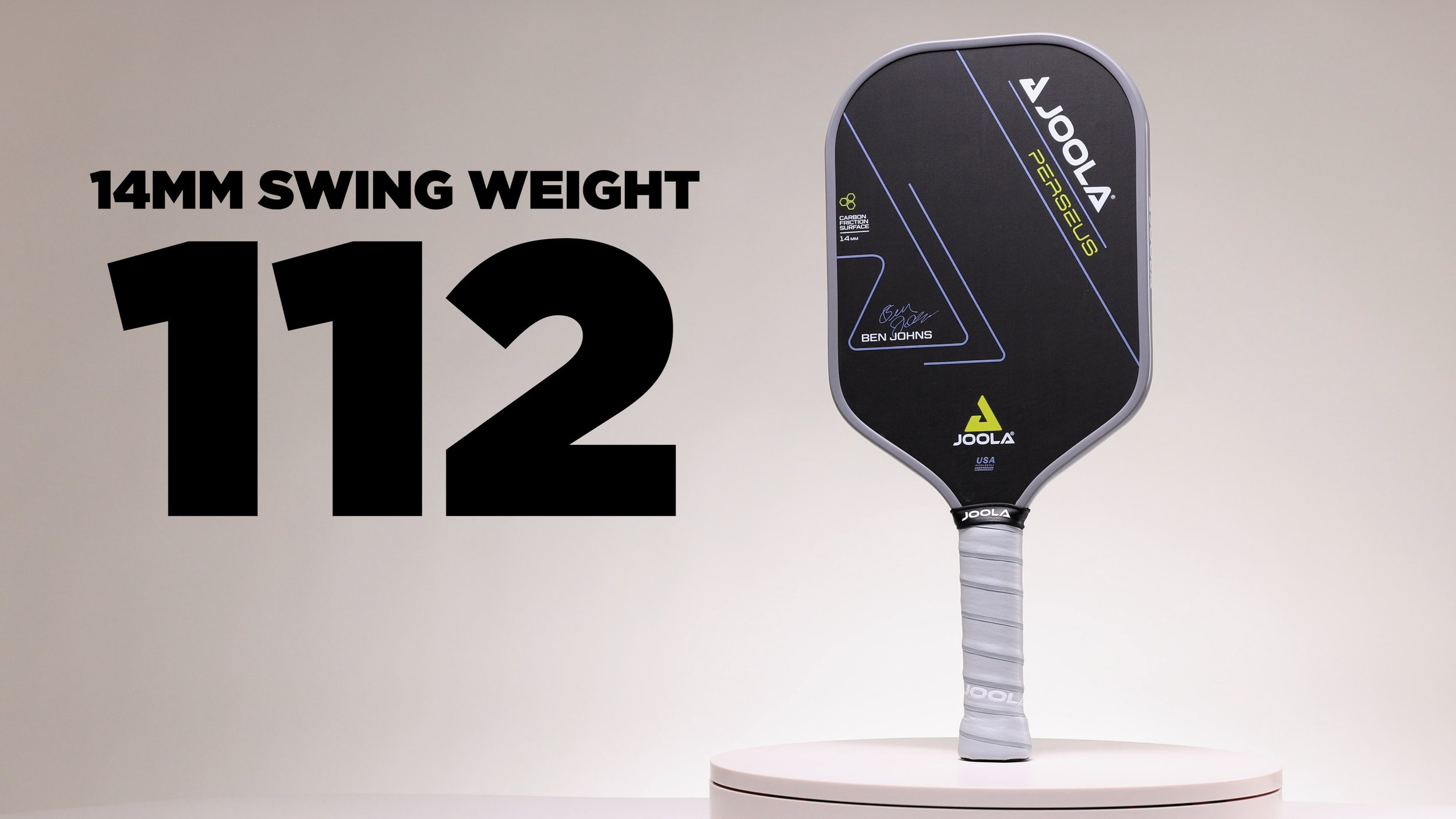 JOOLA Ben Johns Perseus 14mm pickleball paddle with swing weight of 112 displayed on a stand