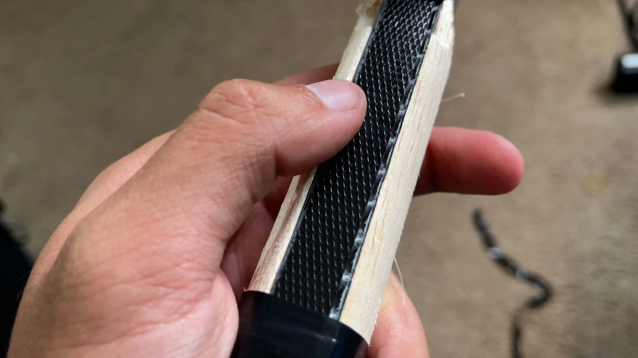 PaddleTek Tempest v3 pickleball paddle edge profile showing carbon fiber face and wooden handle