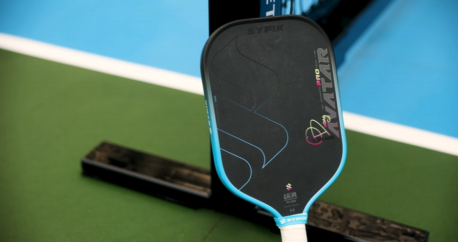 Sypik Avatar pickleball paddle close-up on blue court surface showing face design and branding