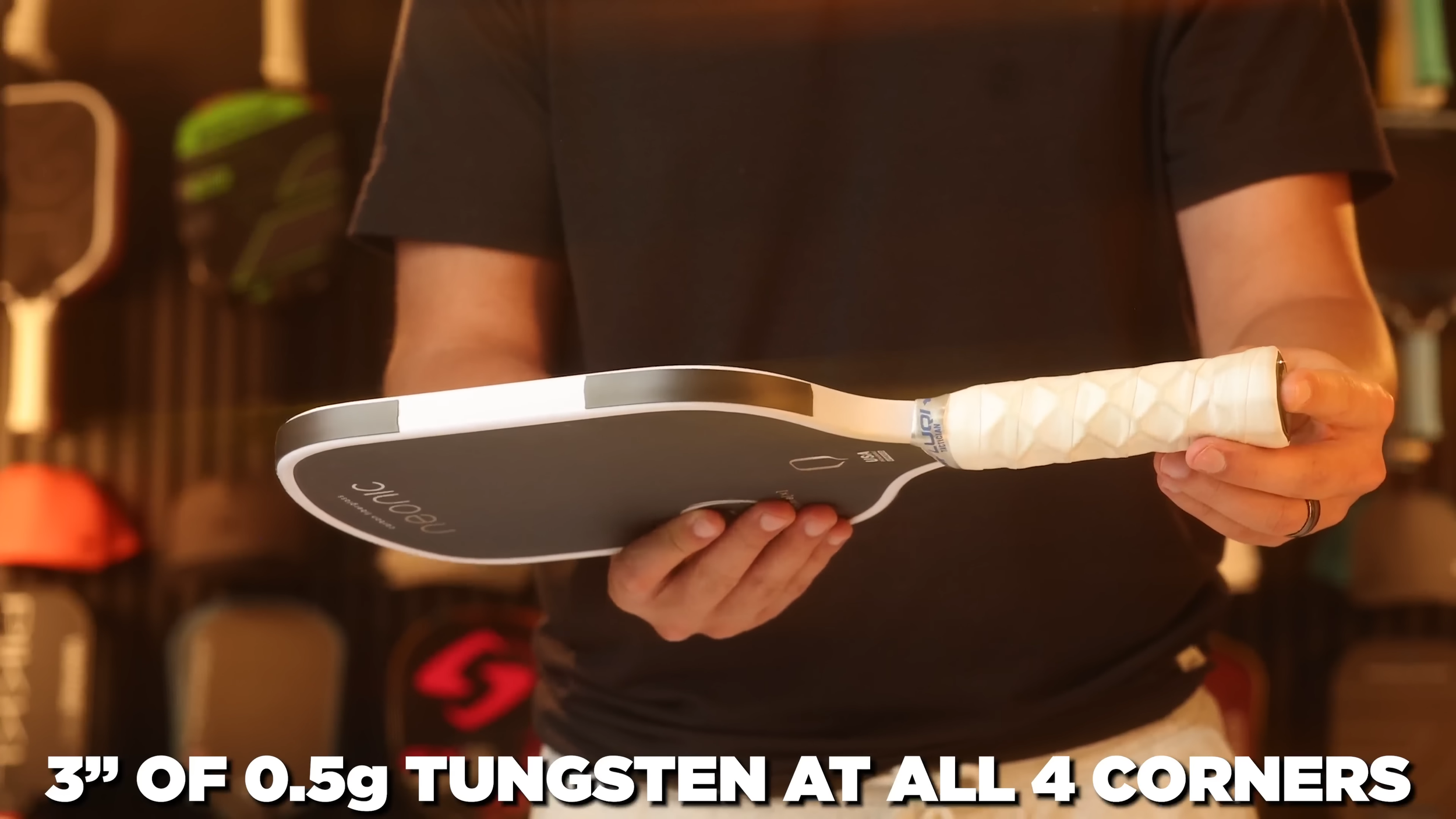 Neonic Flare Prime X pickleball paddle held in hand showing lead tape setup with tungsten at all four corners
