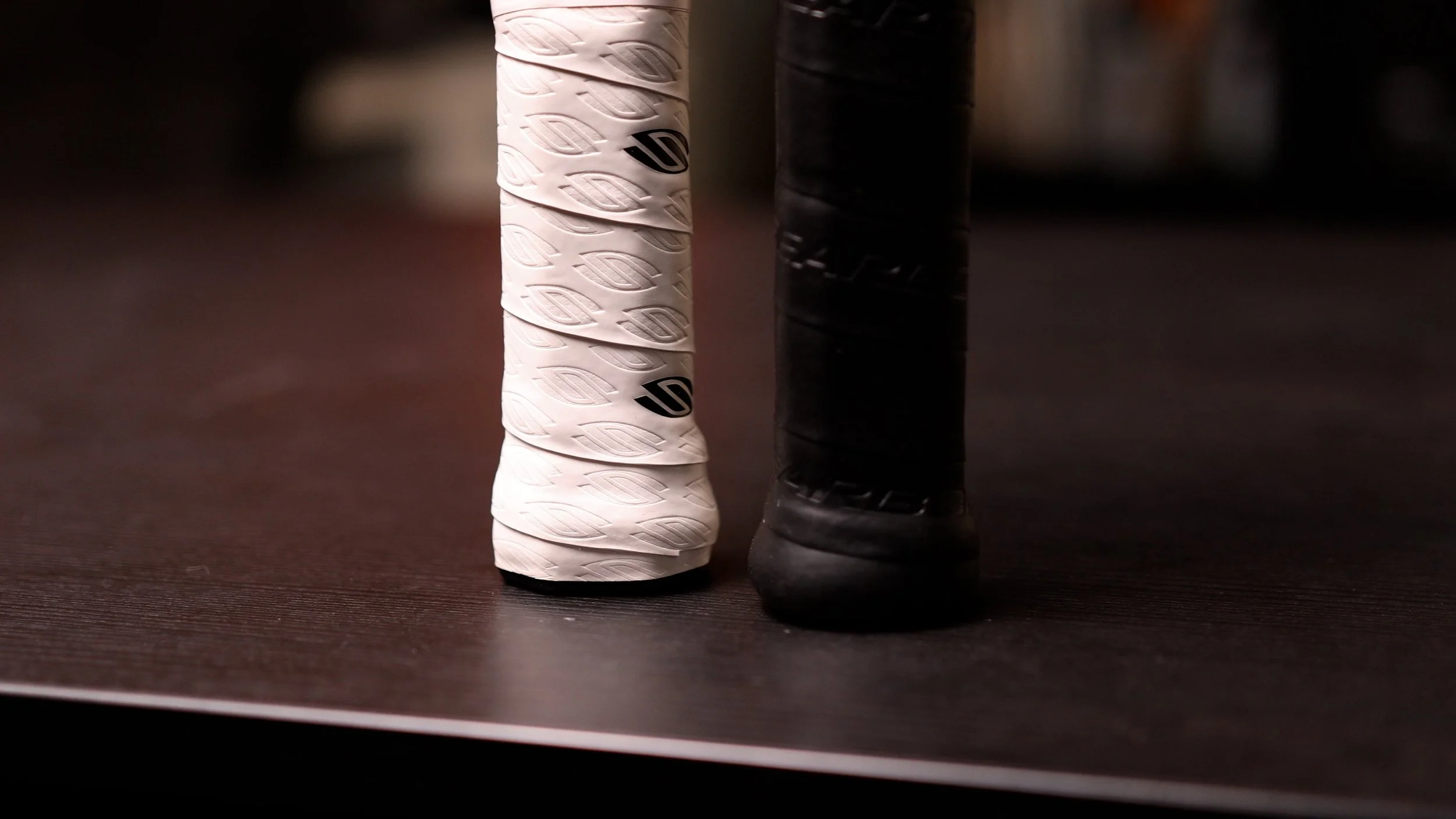 Gearbox CX14 Ultimate pickleball paddle butt caps comparing white overgrip and stock black grip