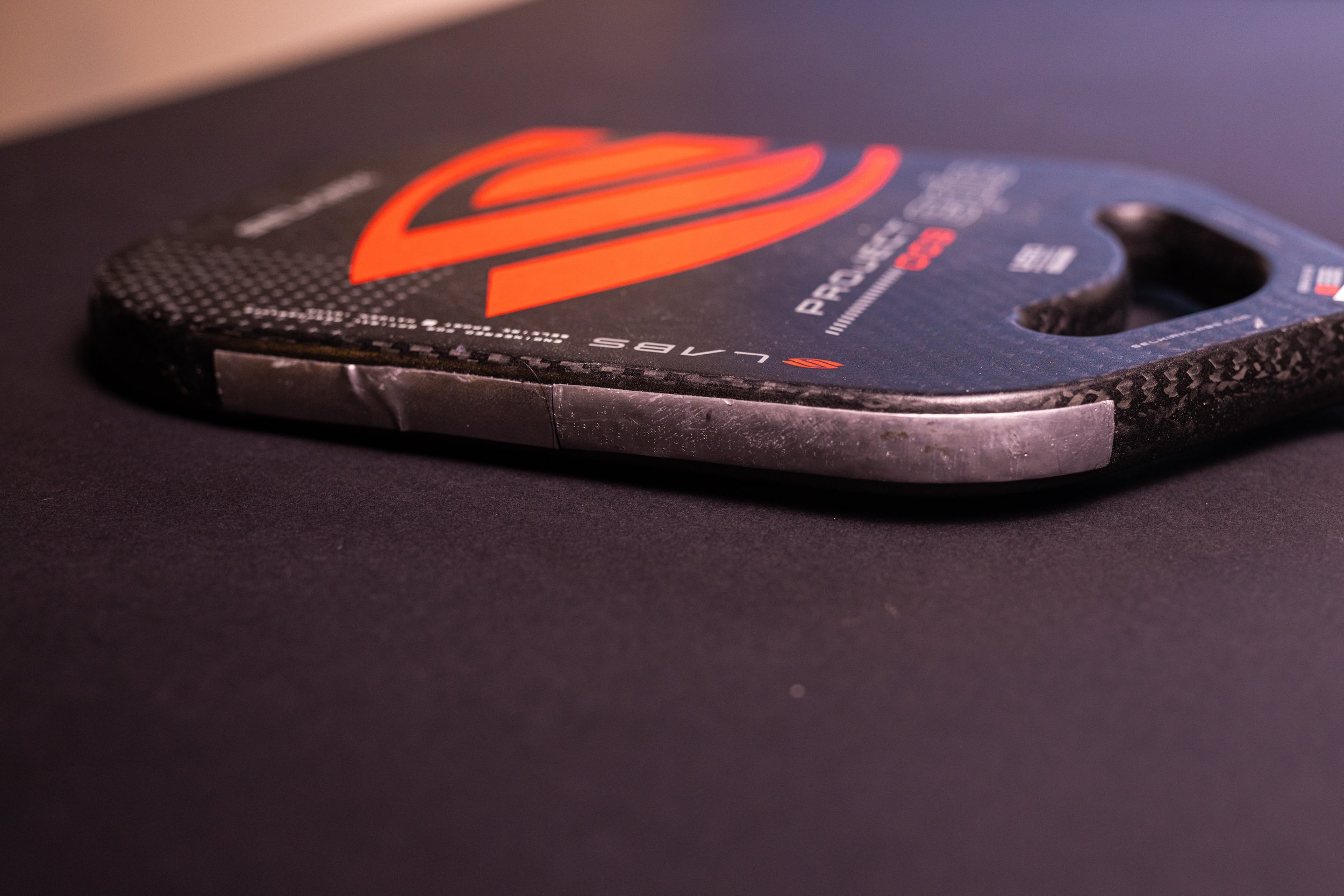 Selkirk Labs Project 003 pickleball paddle close-up showing edge guard and carbon fiber construction