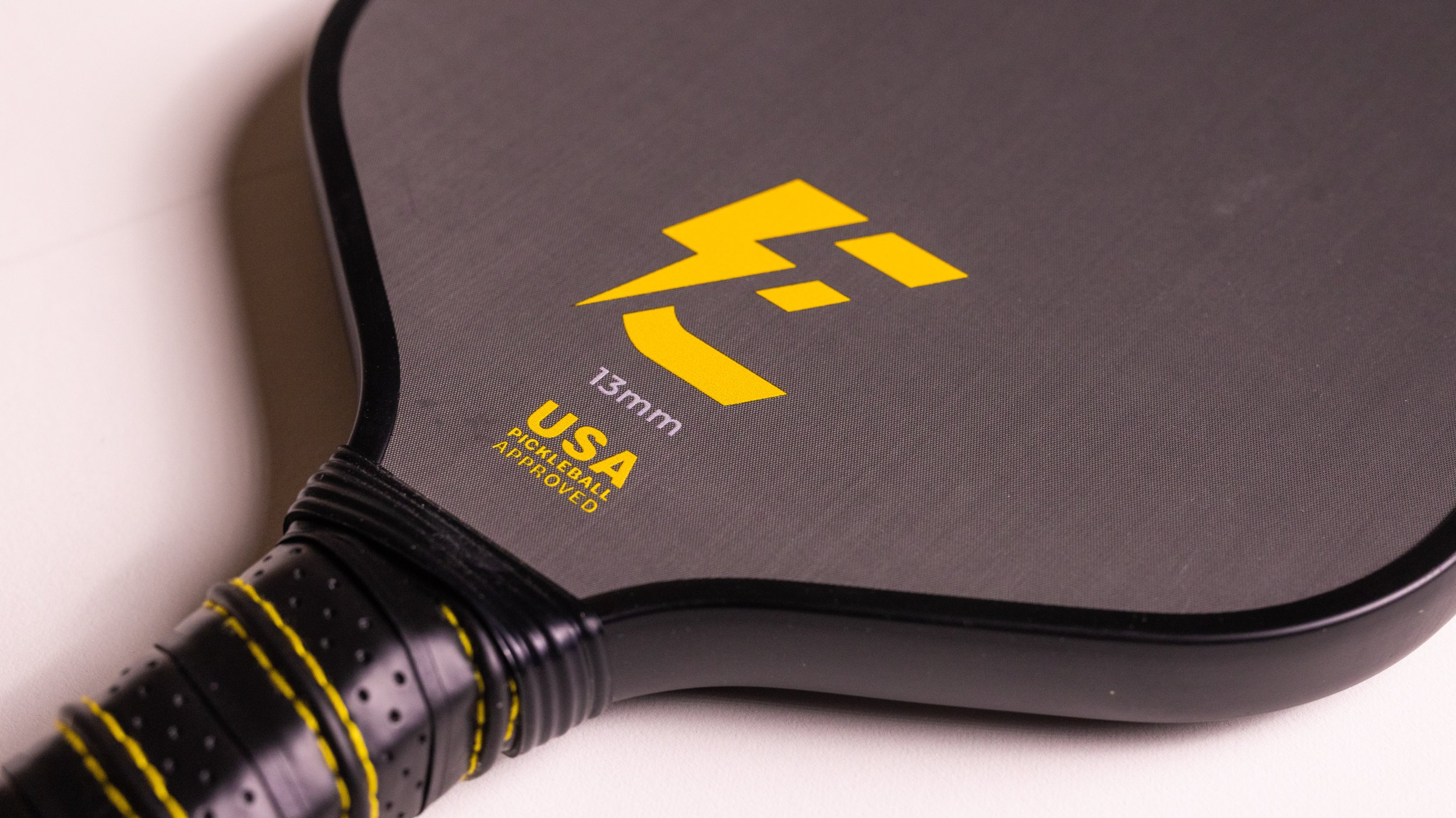 Electrum Model E 13mm pickleball paddle close-up showing face and USA Pickleball approved logo