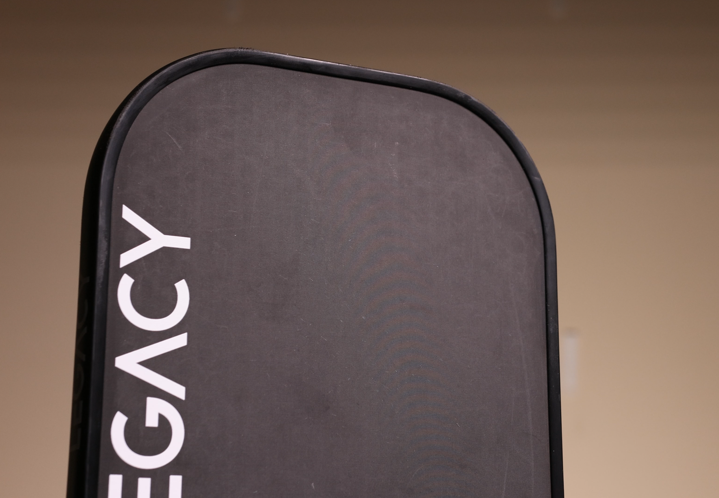 Legacy Pro pickleball paddle top edge showing wear marks after prolonged use