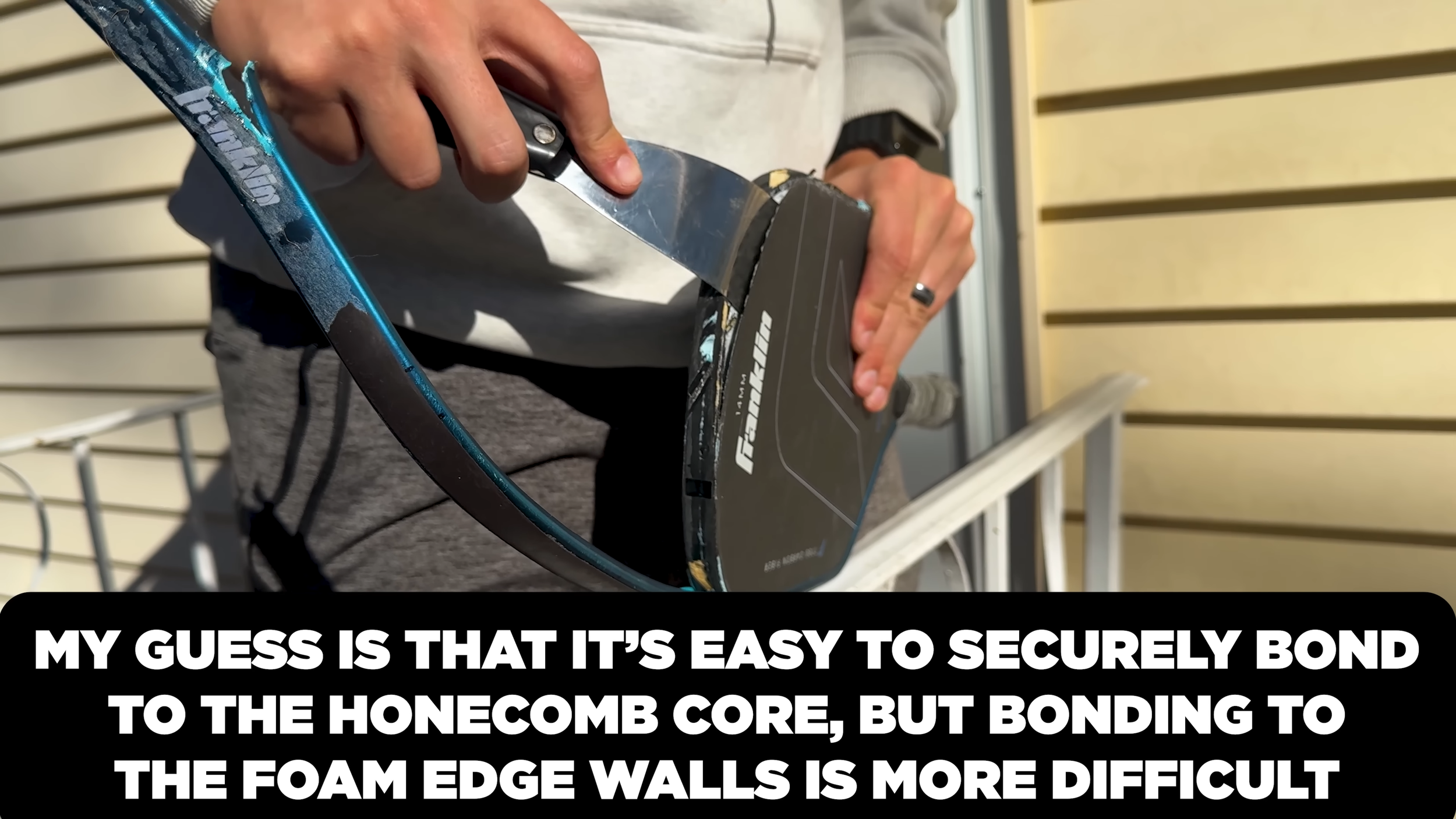 Franklin C45 pickleball paddle being pried open to examine bonding between face and foam edge