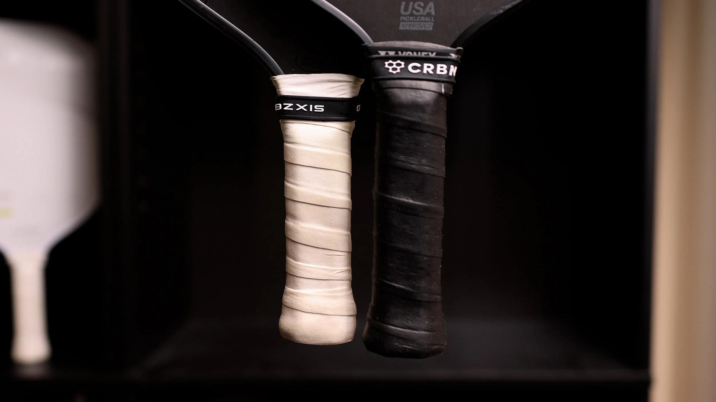 Six Zero and CRBN pickleball paddle handle comparison showing grip sizes side by side